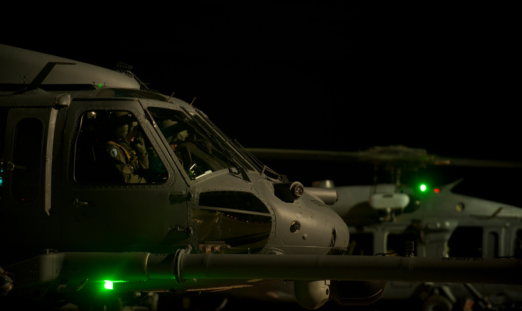 A pair of HH-60G Pave Hawks assigned to the 66th Rescue Squadron prepare for takeoff prior to executing a Red Flag 15-1 personnel recovery training mission at Nellis Air Force Base, Nev., Feb. 5, 2015. A low-light environment and mountainous terrain make training scenarios a challenging test of aircrew proficiency.  (U.S. Air Force photo by Airman 1st Class Joshua Kleinholz)