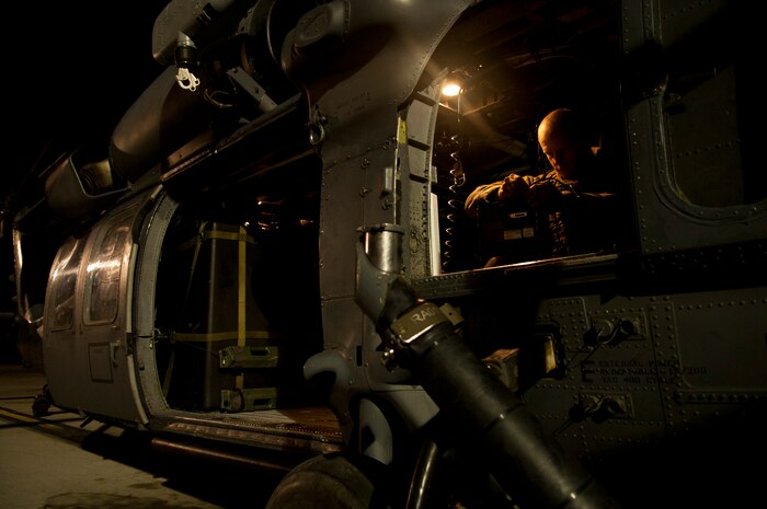 Staff Sgt. Lucas Spain, a special missions aviator assigned the 66th Rescue Squadron, runs through pre-flight checks on an HH-60G Pave Hawk in preparation for a personnel recovery training scenario during Red Flag 15-1 at Nellis Air Force Base, Nev., Feb. 5, 2015. The Pave Hawk can be equipped with two M240 7.62mm machine guns or two GAU-21 .50 caliber machine guns. (U.S. Air Force photo by Airman 1st Class Joshua Kleinholz)