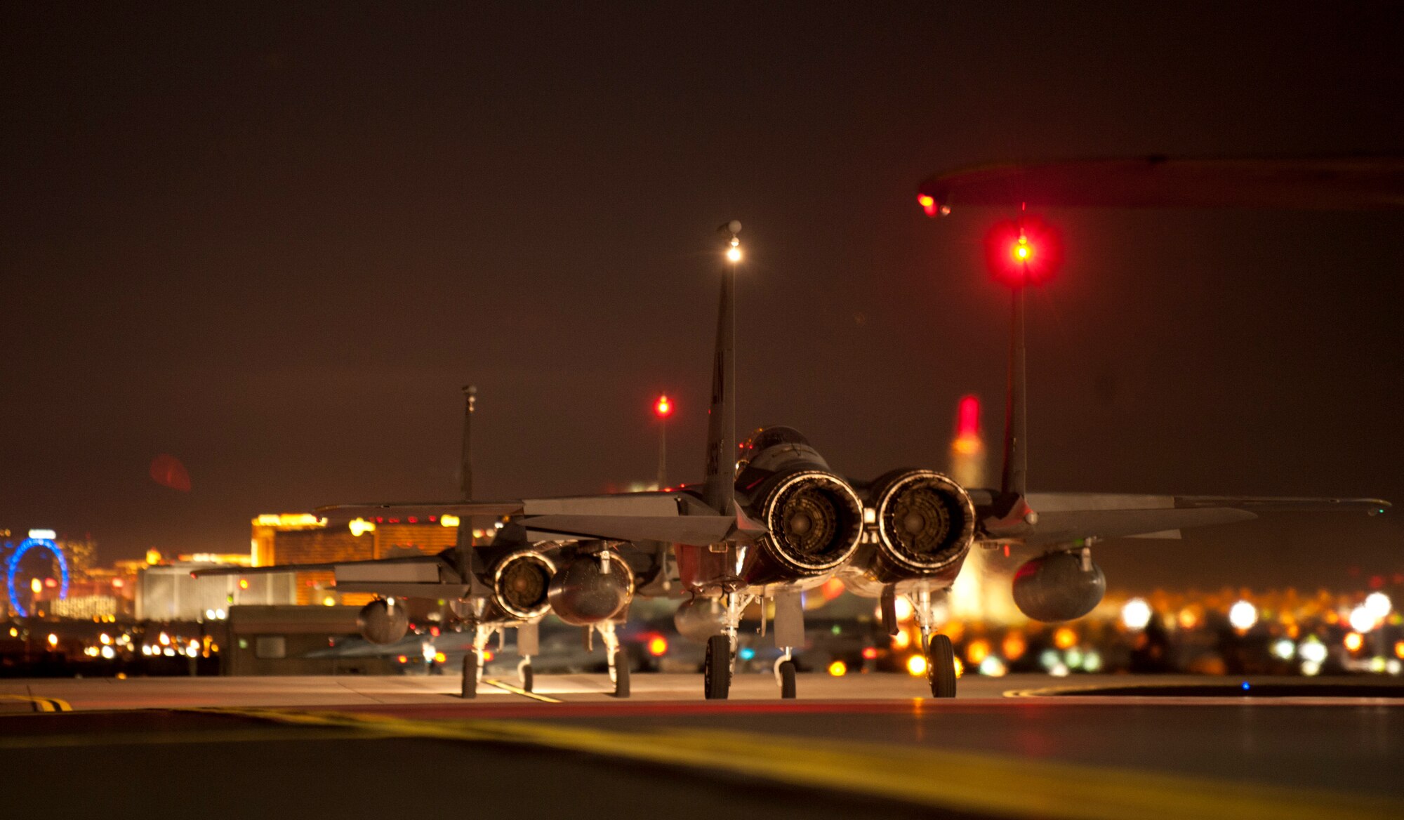 F-15C Eagles assigned to the 493rd Fighter Squadron, Royal Air Force Base, Lakenheath, England, taxi towards the runway moments before taking off to participate in a Red Flag 15-1 training sortie at Nellis Air Force Base, Nev., Feb. 4, 2015. The night operations aspects of Red Flag is crucial for aircrews looking to gain experience in low-light situations, giving U.S. and coalition Air Forces the strategic upper hand in current and future conflicts. (U.S. Air Force photo by Airman 1st Class Joshua Kleinholz)