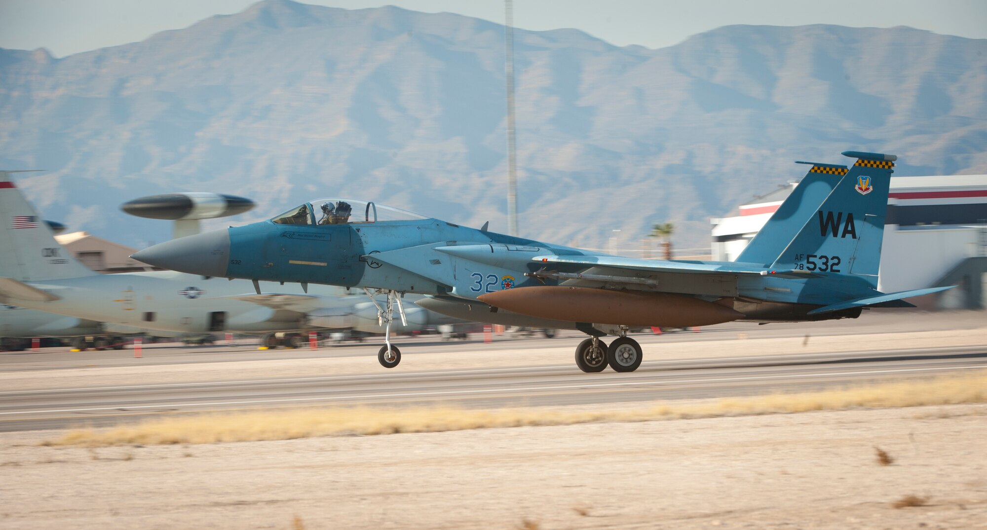 An F-15C Eagle assigned to the 64th Aggressor Squadron, lands following the completion of a Red Flag 15-1 training sortie at Nellis Air Force Base, Nev., Feb. 4, 2015. Pilots and aircrews of the 64 AGRS, paired with space, cyber and intelligence experts within the 57th Adversary Tactics Group, present a credible threat picture for Red Flag coalition “Blue Force” participants. . (U.S. Air Force photo by Airman 1st Class Joshua Kleinholz)