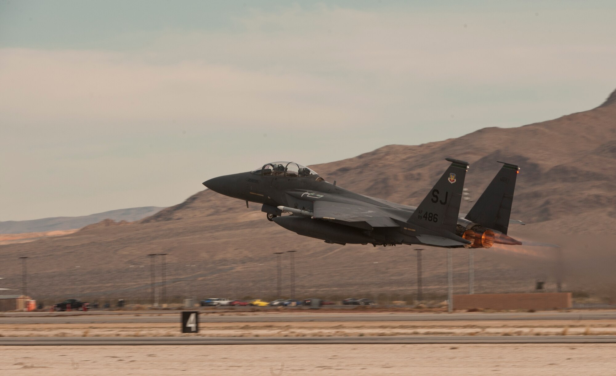 An F-15E Strike Eagle assigned to the 335th Fighter Squadron, Seymour Johnson Air Force Base, N.C., takes off from Nellis Air Force Base, Nev., to take part in a Red Flag 15-1 training sortie over the Nevada Test and Training Range Feb. 4, 2015. Various units from around the Air Force, joint branches and coalition partners converge on Nellis three to four times a year to take part in the exercise, which simulates large-scale live, virtual and constructive warfare. (U.S. Air Force photo by Airman 1st Class Joshua Kleinholz) 