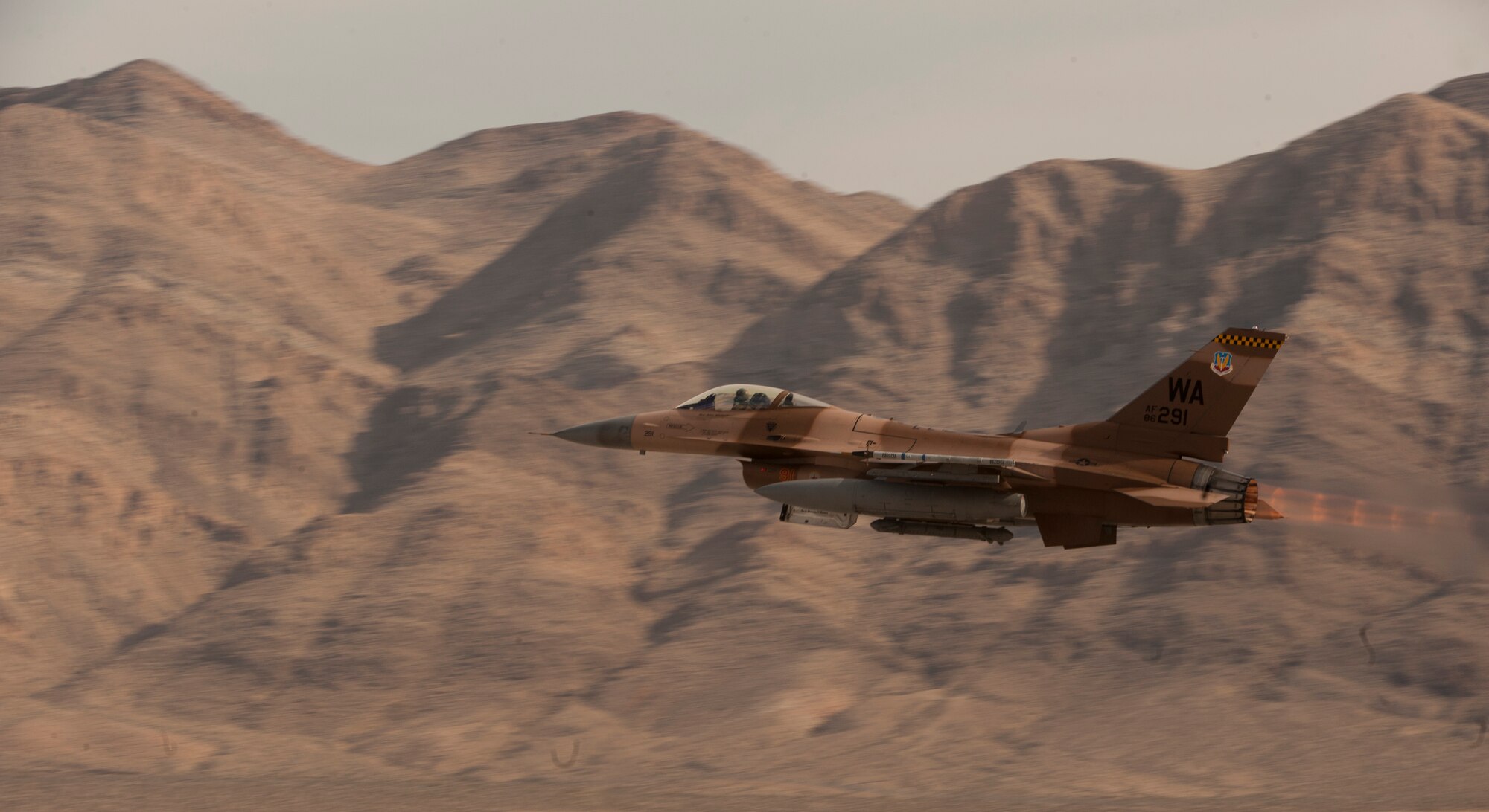 An F-16 Fighting Falcon assigned to the 64th Aggressor Squadron, takes to the sky as part of a Red Flag 15-1 training sortie from Nellis Air Force Base, Nev., Feb. 4, 2015. The 64th AGRS operates F-16s and F-15s in their role as an intelligent, adaptable adversary in support of various air combat exercises. (U.S. Air Force photo by Airman 1st Class Joshua Kleinholz)