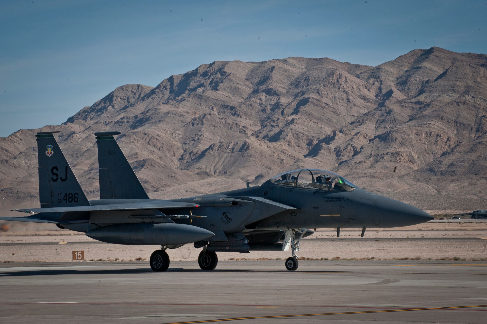 An F-15E Strike Eagle assigned to the 335th Fighter Squadron, Seymour Johnson Air Force Base, N.C., taxis off the runway after landing from a Red Flag 15-1 training sortie at Nellis Air Force Base, Nev., Feb. 2, 2015. Red Flag sorties are typically flown twice a day, a pace that tests both the crews in the air and the maintenance professionals on the ground charged with keeping aircraft in the fight. (U.S. Air Force photo by Airman 1st Class Joshua Kleinholz)