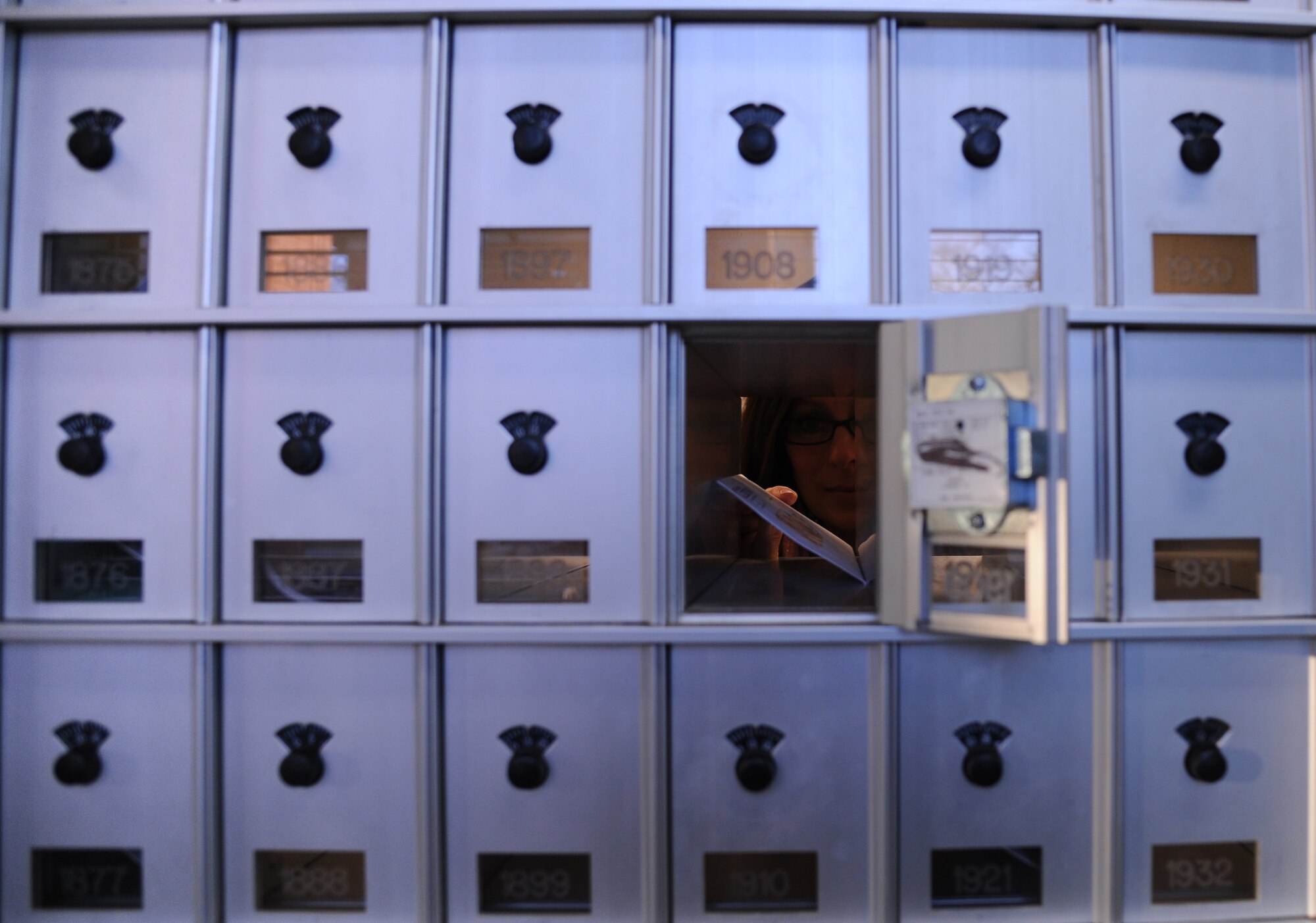 Lauren Womack, a 19th Communications Squadron contracted manager, places an envelope into a mail slot Jan. 15, 2015, at Little Rock Air Force Base, Ark. In addition to delivering mail to different units on base, the official mail center delivers mail to the postal service center, which services Airmen in the dorms and in training. (U.S. Air Force photo by Airman 1st Class Mercedes Muro) 