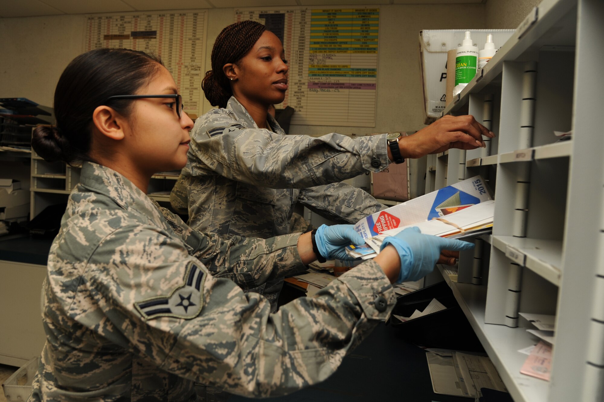 Airman 1st Class Amanda Hernandez and Senior Airman Cordia Wilkins, 19th Communication Squadron official mail clerks, bundle mail and place them in cubicles Jan. 20, 2015, at Little Rock Air Force Base, Ark. To remain organized, mail is bundled together before it is loaded into the truck. (U.S. Air Force photo by Airman 1st Class Mercedes Muro)