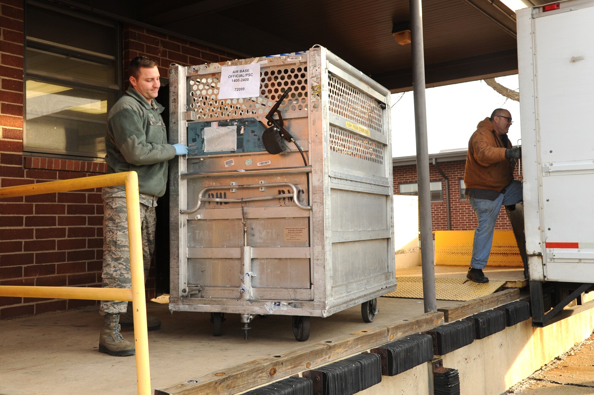 Senior Airman William Heebsh, 19th Communications Squadron official mail clerk, pushes a mail cart into the official mail center Jan. 14, 2015, at Little Rock Air Force Base, Ark. Mail is delivered to the mail center every morning. (U.S. Air Force photo by Airman 1st Class Mercedes Muro)