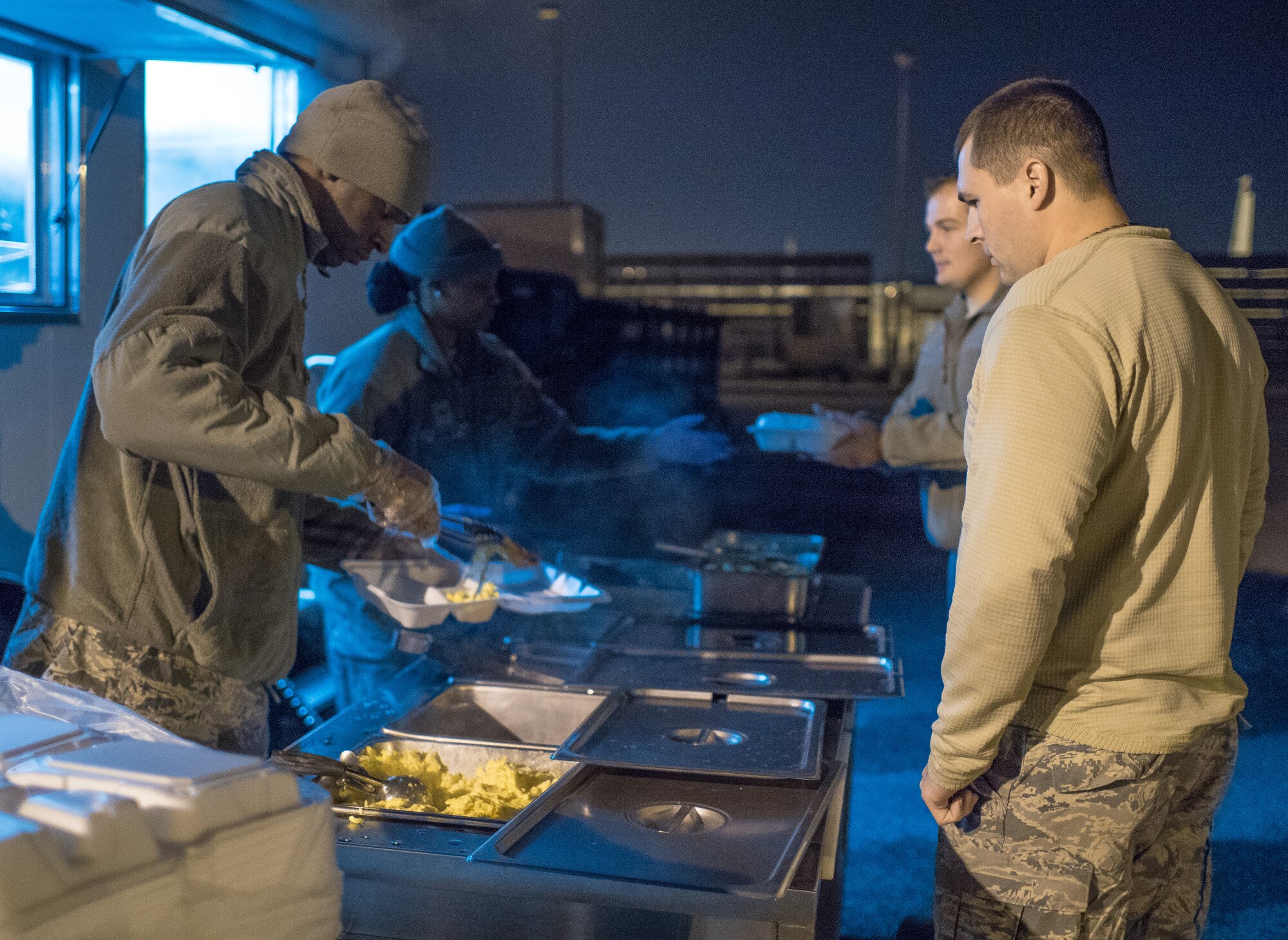 The 116th Services Flight, Georgia Air National Guard, serves a hot breakfast to E-8C Joint STARS aircraft maintainers during drill weekend at Robins Air Force Base, Ga., Feb. 8, 2015. The food service professionals from the 116th Air Control Wing took advantage of the opportunity to perform additional training on the use of their disaster relief mobile kitchen trailer (DRMKT), while providing nightshift aircraft maintenance workers the chance to enjoy a hot meal just off the flightline. The free-standing mobile kitchen, acquired by the unit just over a year ago, is designed for fast setup and teardown and can be transported aboard a C-130 Hercules aircraft. Airmen train on the DRMKT regularly to maintain readiness required to respond to a contingency situation across the Southeast United States. (U.S. Air National Guard photo by Master Sgt. Roger Parsons/Released)