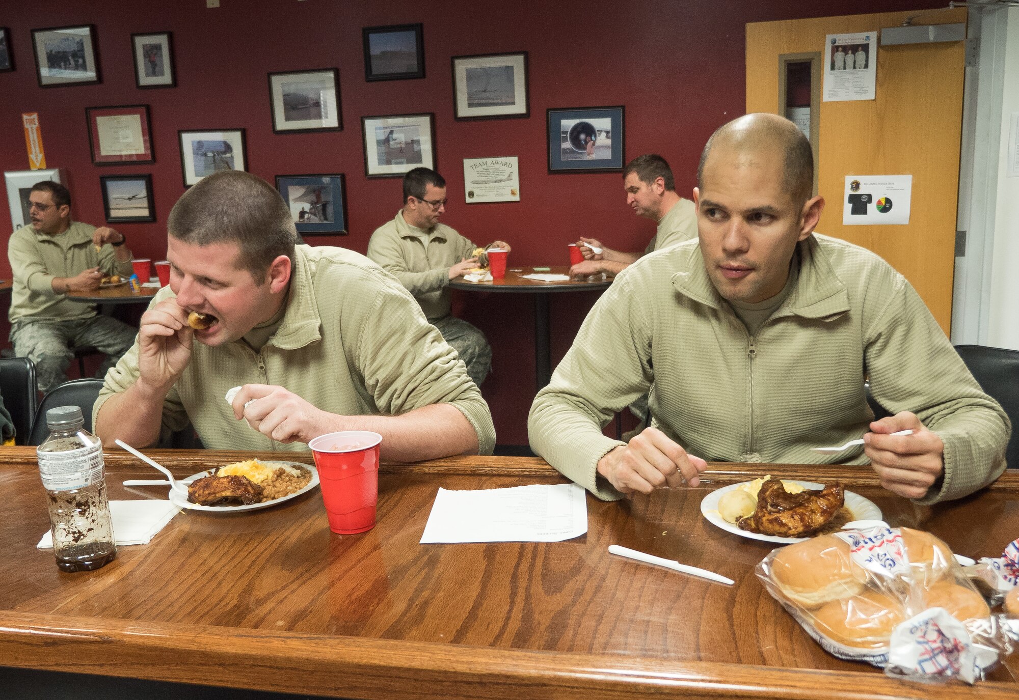 E-8C Joint STARS aircraft maintainers from the 116th Air Control Wing, Georgia Air National Guard, enjoy a hot meal prepared by the 116th Services Flight during drill weekend at Robins Air Force Base, Ga., Feb. 7, 2015. The food service professionals from the 116th Air Control Wing took advantage of the opportunity to perform additional training on the use of their disaster relief mobile kitchen trailer (DRMKT), while providing nightshift aircraft maintenance workers the chance to enjoy a hot meal just off the flightline. The free-standing mobile kitchen, acquired by the unit just over a year ago, is designed for fast setup and teardown and can be transported aboard a C-130 Hercules aircraft. Airmen train on the DRMKT regularly to maintain readiness required to respond to a contingency situation across the Southeast United States. (U.S. Air National Guard photo by Master Sgt. Roger Parsons/Released)