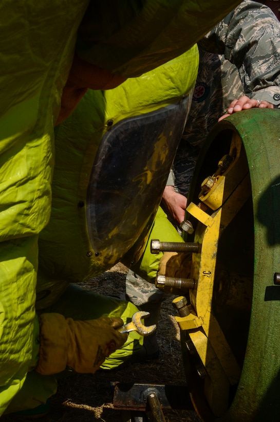 U.S. Air Force Airman 1st Classes Gregory Pease and Nolan Bailey, 612th Air Base Squadron firefighters, work together to seal a leaking valve during a hazardous material exercise on Soto Cano Air Base, Honduras, Feb. 10, 2015. The training exercise was held to guarantee members assigned to the 612th ABS Fire Department are compliant with the Department of Defense’s requirement that all Air Force firefighters are certified to the hazmat technical level. (U.S. Air Force photo/Tech. Sgt. Heather Redman)