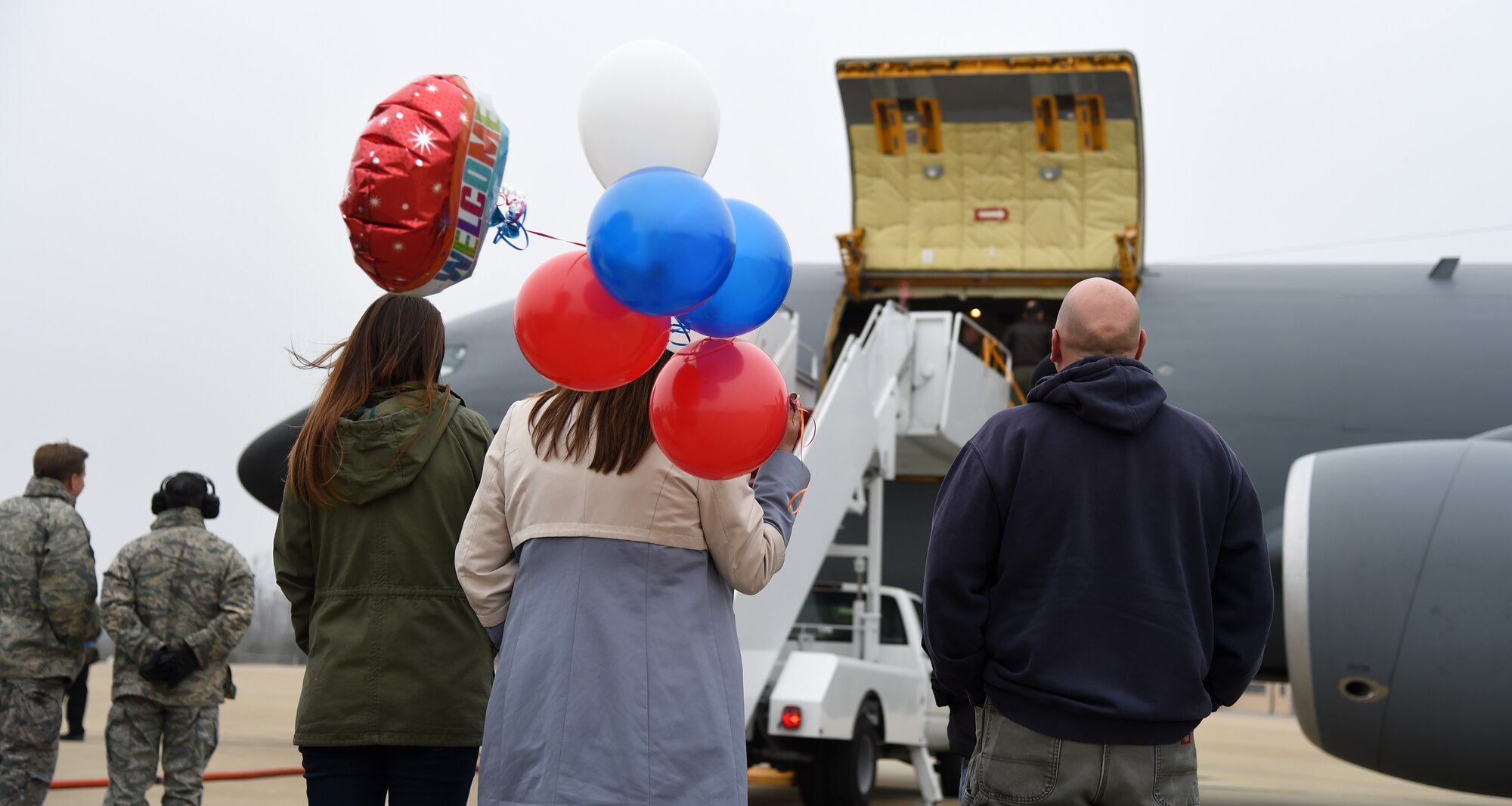 Family of a 459th Air Refueling Wing member holds welcome balloons as they wait to be reunited on the flightline at Joint Base Andrews, Md., Feb. 9, 2014. (U.S. Air Force photo/Airman 1st Class Philip Bryant)