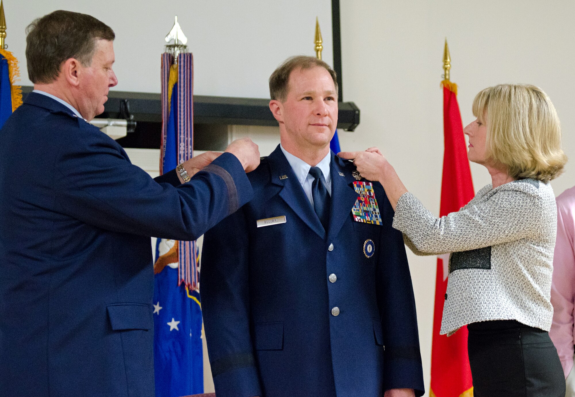 Steven P. Bullard (center), chief of staff for Headquarters, Kentucky Air National Guard, is promoted to the rank of brigadier general during a ceremony held at the Kentucky Air National Guard Base in Louisville, Ky., Feb. 7, 2015. Pinning new rank insignia to Bullard’s uniform are his wife, Janice, and Maj. Gen. Edward W. Tonini, adjutant general for the Commonwealth of Kentucky. (U.S. Air National Guard photo by Master Sgt. Phil Speck)