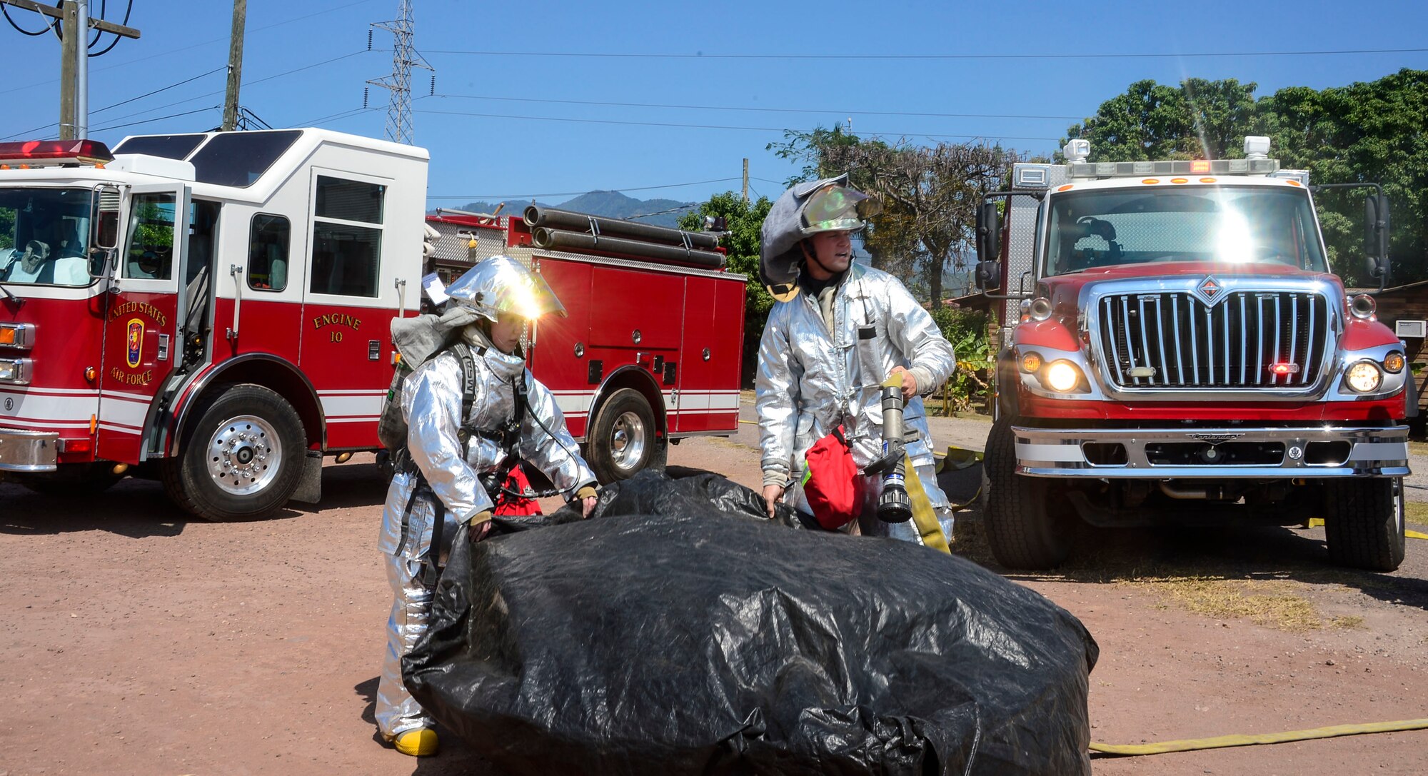 U.S. Air Force Airman 1st Class Adrianna Hopkins and U.S. Air Force Staff Sgt. Daniel Easterlund, 612th Air Base Squadron firefighters, set up a decontamination bath during a hazardous material exercise on Soto Cano Air Base, Honduras, Feb. 10, 2015. The training exercise was held to guarantee members assigned to the 612th ABS Fire Department are compliant with the Department of Defense’s requirement that all Air Force firefighters are certified to the hazmat technical level. (U.S. Air Force photo/Tech. Sgt. Heather Redman)