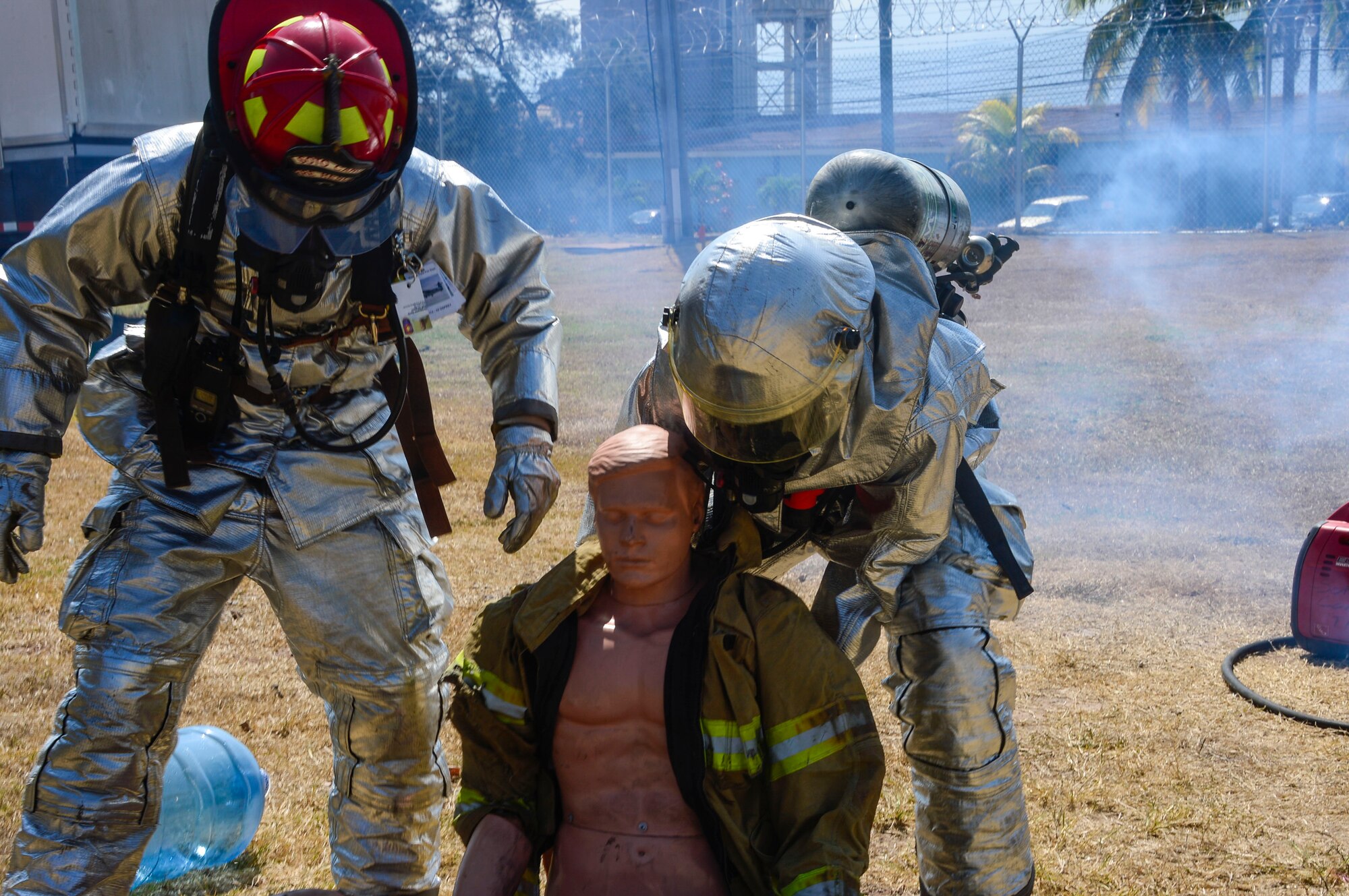 U.S. Air Force Staff Sgt. Christopher Harris and U.S. Air Force Senior Airman Collin Lorash, 612th Air Base Squadron firefighters, help remove a dummy from the area of a simulated chlorine spill during a hazardous material exercise on Soto Cano Air Base, Honduras, Feb. 10, 2015. The training exercise was held to guarantee members assigned to the 612th ABS Fire Department are compliant with the Department of Defense’s requirement that all Air Force firefighters are certified to the hazmat technical level. (U.S. Air Force photo/Tech. Sgt. Heather Redman)