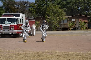 U.S. Air Force Senior Airman Collin Lorash and U.S. Air Force Staff Sgt. Christopher Harris, 612th Air Base Squadron firefighters, rush to the scene of a hazardous material exercise on Soto Cano Air Base, Honduras, Feb. 10, 2015. The training exercise was held to guarantee members assigned to the 612th ABS Fire Department are compliant with the Department of Defense’s requirement that all Air Force firefighters are certified to the hazmat technical level. (U.S. Air Force photo/Tech. Sgt. Heather Redman)