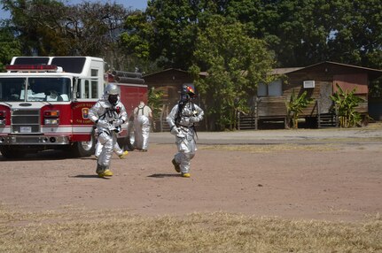 U.S. Air Force Senior Airman Collin Lorash and U.S. Air Force Staff Sgt. Christopher Harris, 612th Air Base Squadron firefighters, rush to the scene of a hazardous material exercise on Soto Cano Air Base, Honduras, Feb. 10, 2015. The training exercise was held to guarantee members assigned to the 612th ABS Fire Department are compliant with the Department of Defense’s requirement that all Air Force firefighters are certified to the hazmat technical level. (U.S. Air Force photo/Tech. Sgt. Heather Redman)