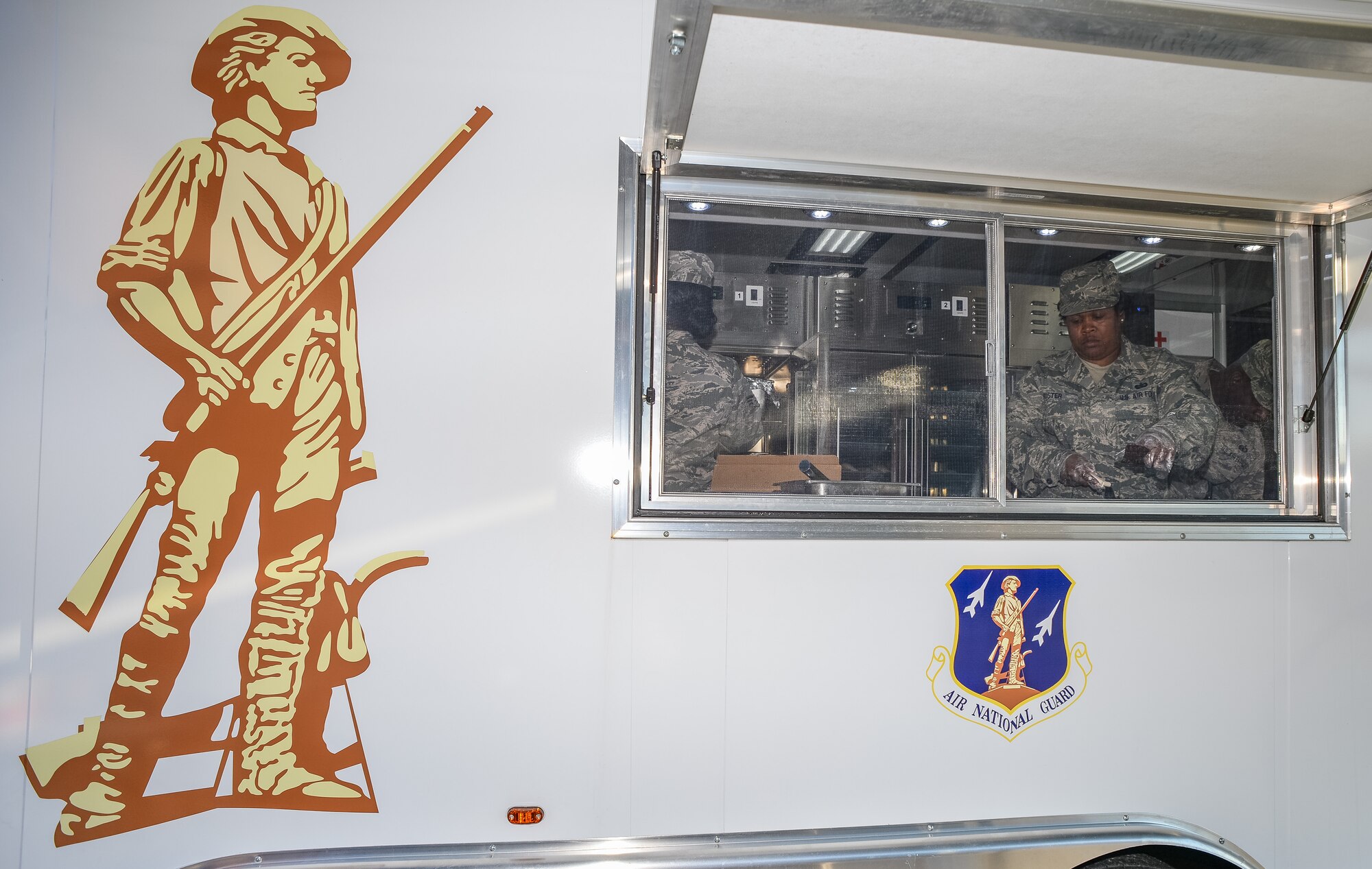 The 116th Services Flight, Georgia Air National Guard, prepares a hot meal for E-8C Joint STARS aircraft maintainers during drill weekend at Robins Air Force Base, Ga., Feb. 7, 2015. The food service professionals from the 116th Air Control Wing took advantage of the opportunity to perform additional training on the use of their disaster relief mobile kitchen trailer (DRMKT), while providing nightshift aircraft maintenance workers the chance to enjoy a hot meal just off the flightline. The free-standing mobile kitchen, acquired by the unit just over a year ago, is designed for fast setup and teardown and can be transported aboard a C-130 Hercules aircraft. Airmen train on the DRMKT regularly to maintain readiness required to respond to a contingency situation across the Southeast United States. (U.S. Air National Guard photo by Master Sgt. Roger Parsons/Released)