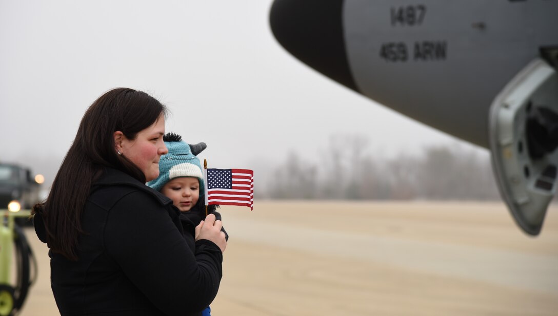 Megan McAlister and son Colin await husband and father, Tech. Sgt. Chris McAlister, 756th Air Refueling Squadron KC-135 Stratotanker boom operator, on the flightline at Joint Base Andrews, Md., Feb. 9, 2015. McAlister was deployed to the 379th Air Expeditionary Wing at an undisclosed location in southwest Asia. He was separated from his wife and eight-month-old son for two months. (U.S. Air Force photo/Airman 1st Class Philip Bryant)