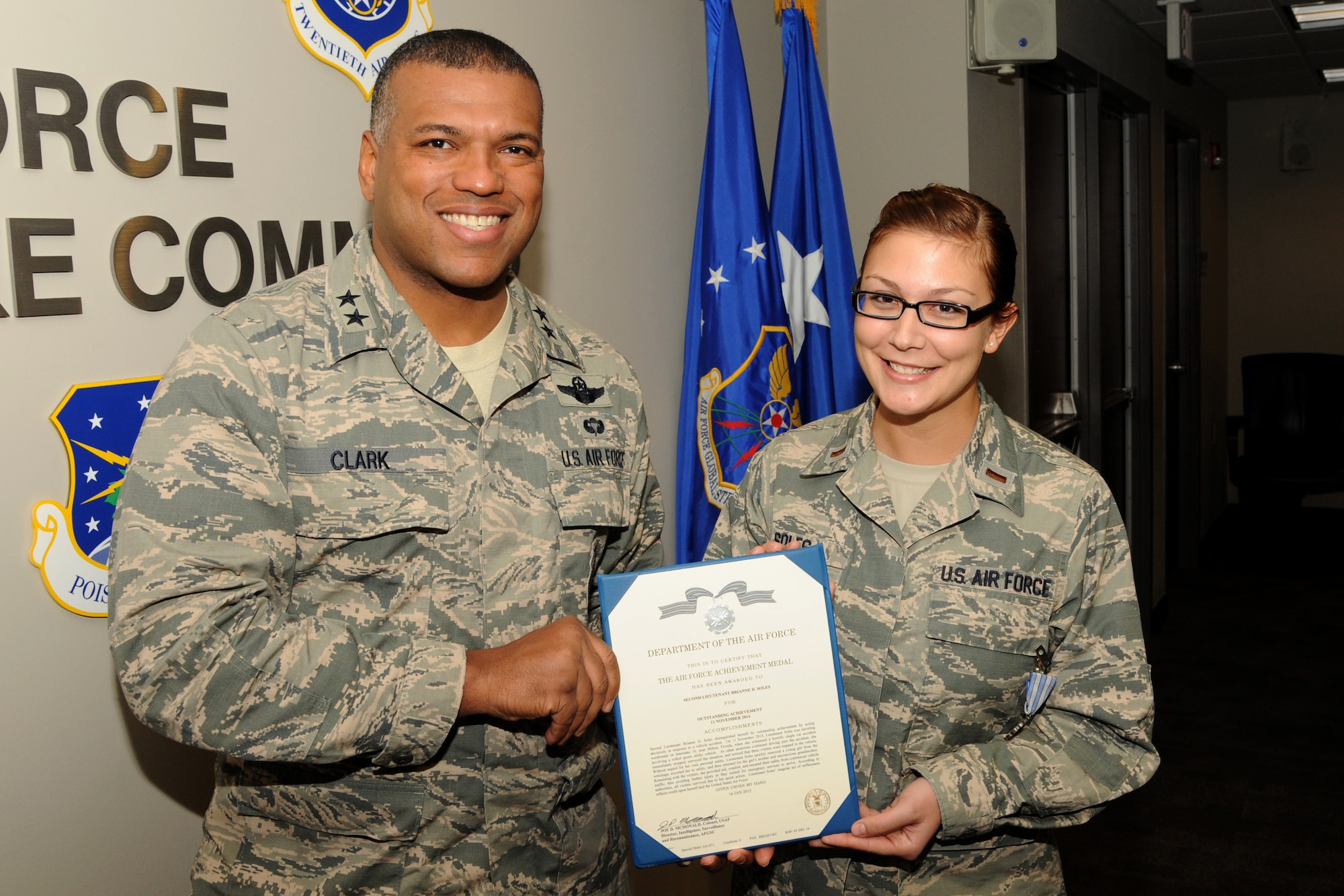 Maj. Gen. Richard Clark, Air Force Global Strike Command vice commander, presents 2nd Lt. Brianne Soles, AFGSC command briefer assigned to the Intelligence Directorate, with an Air Force Achievement Medal Jan. 29, 2015, for her response to a vehicle accident near Milton, Fla., Nov. 11, 2014, where a sport utility vehicle rolled, trapping three passengers inside. (U.S. Air Force photo/Master Sgt. Tim Jenkins)