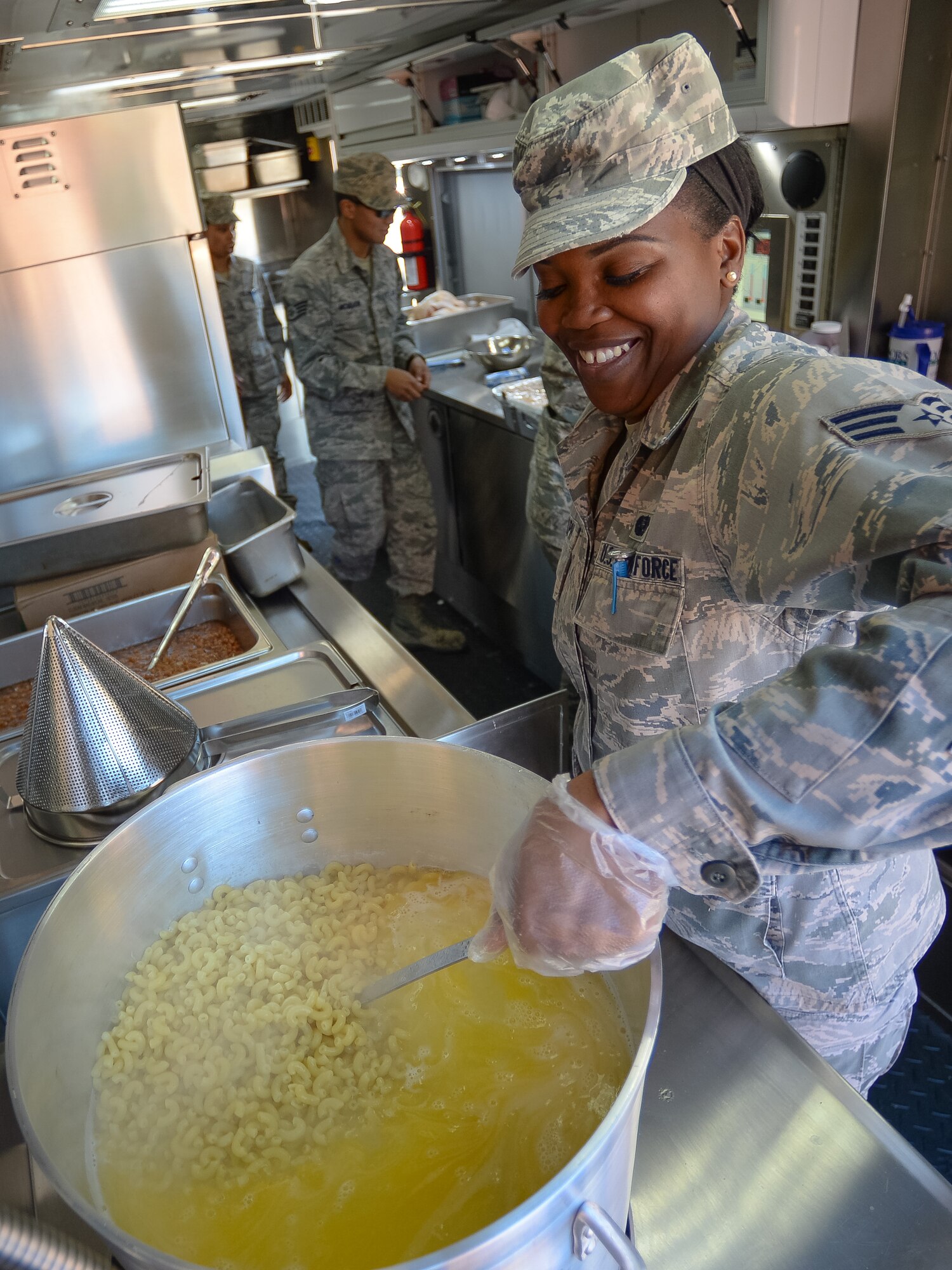An Airman from the 116th Services Flight, Georgia Air National Guard, cooks a pot of macaroni while preparing a hot meal for E-8C Joint STARS aircraft maintainers during drill weekend at Robins Air Force Base, Ga., Feb. 7, 2015. The food service professionals from the 116th Air Control Wing took advantage of the opportunity to perform additional training on the use of their disaster relief mobile kitchen trailer (DRMKT), while providing nightshift aircraft maintenance workers the chance to enjoy a hot meal just off the flightline. The free-standing mobile kitchen, acquired by the unit just over a year ago, is designed for fast setup and teardown and can be transported aboard a C-130 Hercules aircraft. Airmen train on the DRMKT regularly to maintain readiness required to respond to a contingency situation across the Southeast United States. (U.S. Air National Guard photo by Master Sgt. Roger Parsons/Released)