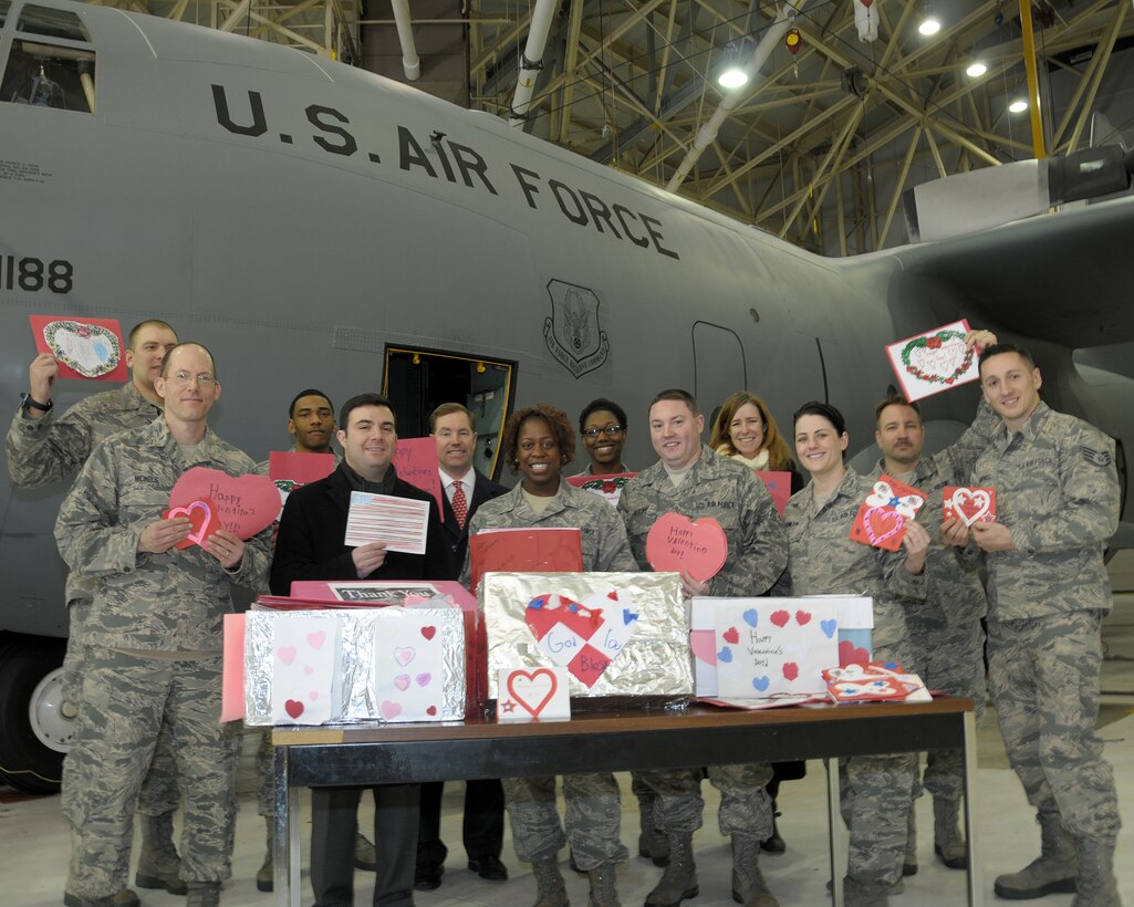Members from the 914th  and 107th  Airlift Wings display their custom made valentine cards at the Niagara Falls Air Reserve Station, N.Y. on February 10, 2015.  Erie County Legislatures Mr. Joseph Lorigo, District 10 (Front row left), Mr. Ed Rath III, District 6 (Back row), and Ms. Lynne Dixon District 9 (Back row) delivered hundreds of custom made valentine cards from children of various local schools in Erie County, N.Y. who prepared these cards and many more with love and admiration to many local Western New York military members. (U.S. Air Force photo by Peter Borys) 