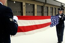 Senior Airmen Whitney Eisinger and Donald Myers, Malmstrom Air Force Base Honor Guard members, practice a two-person flag fold during their honor guard duty week. Honor guard members are required to attend two eight-hour days of training and practice at the beginning of their duty week. They are on-call throughout the full duty week. (U.S. Air Force photo/Staff Sgt. Delia Marchick)