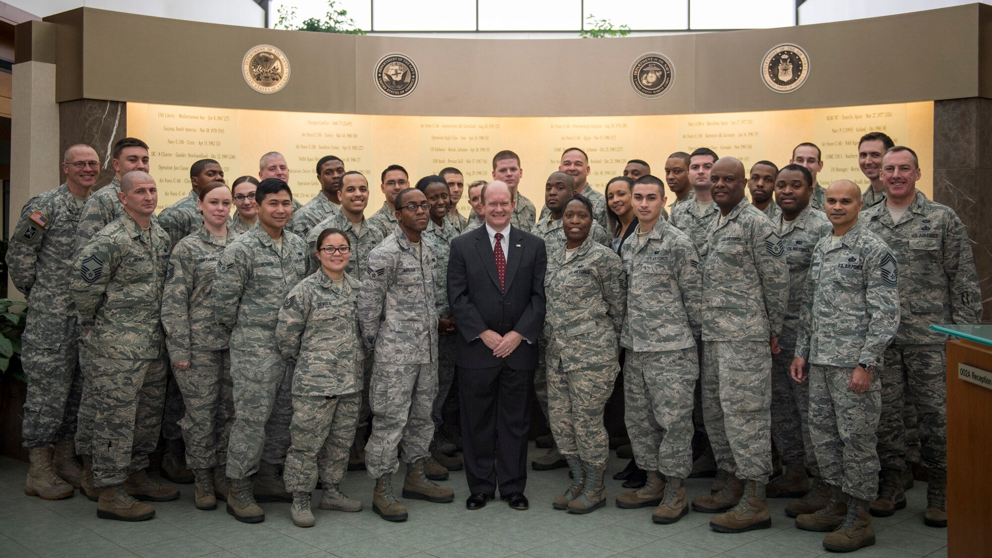 Sen. Chris Coons of Delaware poses for a group photo with Airmen from Air Force Mortuary Affairs Operations Feb. 9, 2015, during a visit to Dover Air Force Base, Del. The senator and his staff met with Airmen to learn more about operations at the Department of Defense’s sole port mortuary. (U.S. Air Force photo by Capt. Ray Geoffroy)