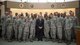 Sen. Chris Coons of Delaware poses for a group photo with Airmen from Air Force Mortuary Affairs Operations Feb. 9, 2015, during a visit to Dover Air Force Base, Del. The senator and his staff met with Airmen to learn more about operations at the Department of Defense’s sole port mortuary. (U.S. Air Force photo by Capt. Ray Geoffroy)