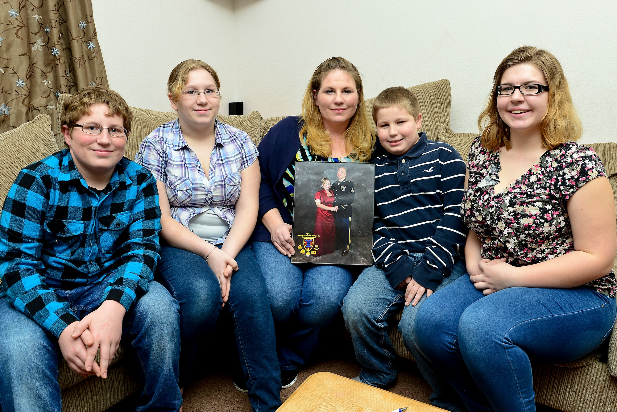 The family of U.S. Army Sgt. Justin Hughes, 510th Human Resource Company wheel vehicle mechanic, display a photo of Hughes and his wife, Linda, at Fort Eustis, Va., Feb. 6, 2015. Although Hughes has missed holidays due to deployments, the family said they always remember him in spirit and look forward to his homecoming. (U.S. Air Force photo by Senior Airman Kimberly Nagle/Released)