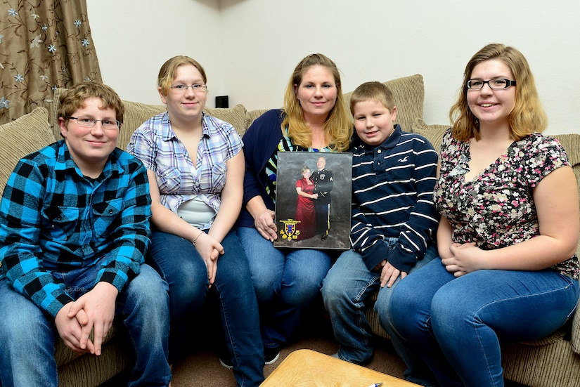 The family of U.S. Army Sgt. Justin Hughes, 510th Human Resource Company wheel vehicle mechanic, display a photo of Hughes and his wife, Linda, at Fort Eustis, Va., Feb. 6, 2015. Although Hughes has missed holidays due to deployments, the family said they always remember him in spirit and look forward to his homecoming. (U.S. Air Force photo by Senior Airman Kimberly Nagle/Released)