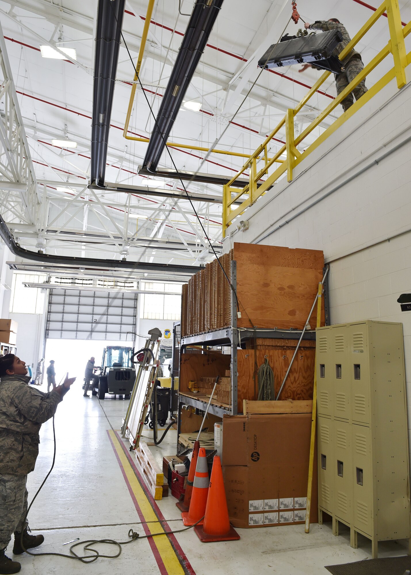 Air Force Reserve Tech. Sgt. Jessica Syverson and Staff Sgt. Silvia Martel, air transportation technicians assigned to the 76th Aerial Port Squadron (APS), move cases for storage during the Unit Training Assembly here, Feb. 7, 2015. U.S. Air Force photo by Senior Airman Rachel Kocin.