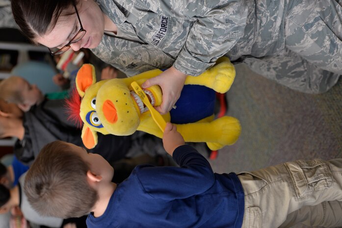 Liam Staten practices brushing the teeth of Dudley the Dinosaur Feb. 10, 2015 at the General Thomas R. Mikolajcik Child Development Center on Joint Base Charleston, S.C. In honor of Children’s Dental Health Month, the 628th Medical Group Dental Clinic educated more than 90 children on the importance of brushing their teeth and eating healthy snacks. Each child was given a dental goodie bag containing a toothbrush, toothpaste and a Mr. Tooth activity book. Staten is the son of Staff Sgt. Jeremy Staten, 437th Maintenance Group. (U.S. Air Force photo / Trisha Gallaway)