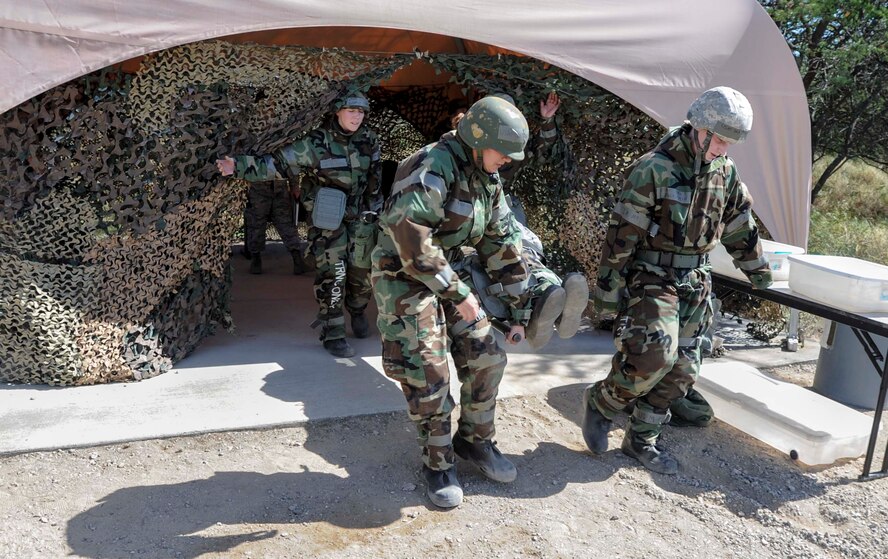 Members of the 15th Wing Staff Agencies carry a simulated casualty to the Casualty Collection Point during a chemical, biological, radiation, nuclear and explosive exercise at Base X on Joint Base Pearl Harbor-Hickam, Hawaii, Feb. 6, 2015. The exercise tested the group’s ability to survive and operate in a hostile or chemical environment. (U.S. Air Force photo by Tech. Sgt. Terri Paden/RELEASED)