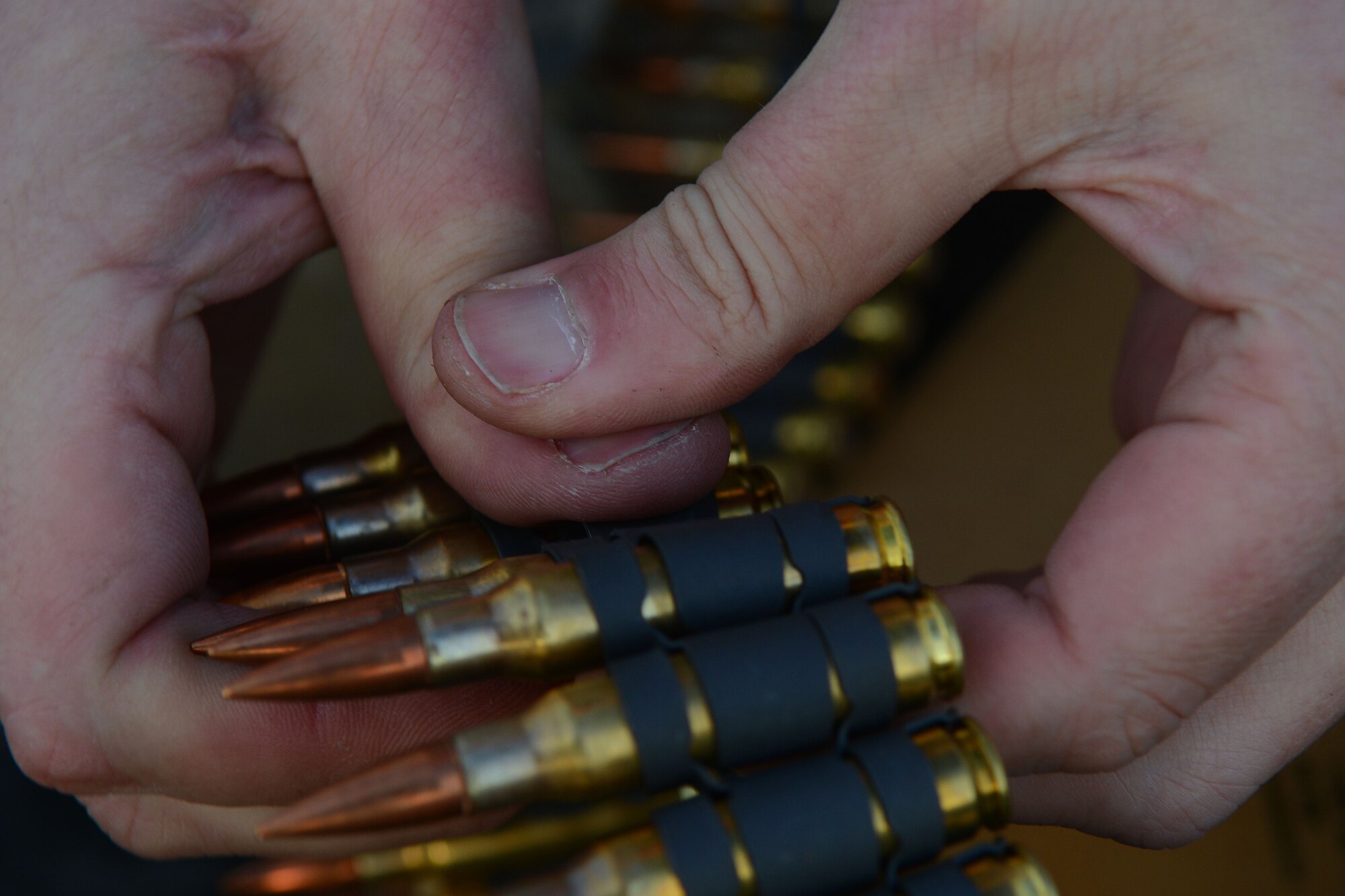 A U.S. Army National Guard soldier assigned to the 1st Battalion, 169th Aviation Regiment, Ft. Bragg, N.C., attaches belts of ammunition at Poinsett Electronic Combat Range, Sumter, S.C., Feb. 6, 2015. In 2013, the range provided training for 754 aircraft from three Department of Defense services and three National Guard stations. (U.S. Air Force photo by Airman 1st Class Michael Cossaboom/Released)