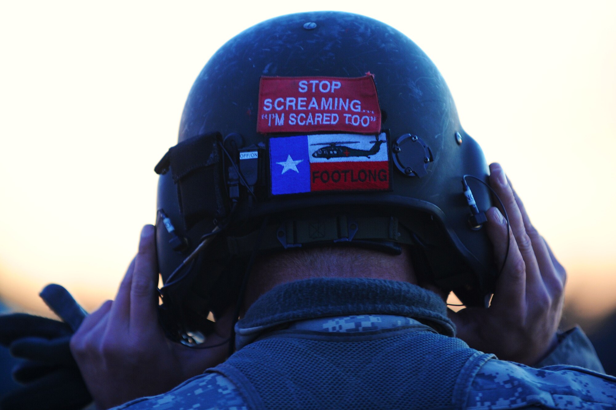 A U.S. Army National Guard soldier assigned to the 1st Battalion, 169th Aviation Regiment, Ft. Bragg, N.C., dons his flight helmet at Poinsett Electronic Combat Range, Sumter, S.C., Feb. 6, 2015. The soldiers used Poinsett Friday and Saturday to train on ground and air gunnery. (U.S. Air Force photo by Airman 1st Class Michael Cossaboom/Released)