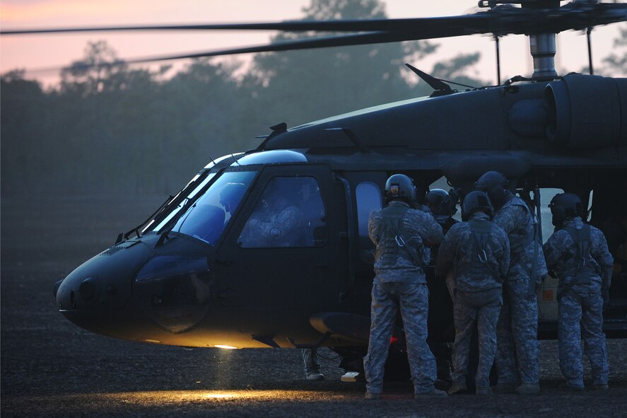 U.S. Army National Guard soldiers assigned to the 1st Battalion, 169th Aviation Regiment, Ft. Bragg, N.C., adjust a mounted M240 machine gun on a UH-60 Black Hawk at Poinsett Electronic Combat Range, Sumter, S.C., Feb. 6, 2015. In 2013, Poinsett had 754 aircraft use its range for training including the F-16CM Fighting Falcon, F-15E Strike Eagle, F/A-18 Super Hornet, UH-60 Black Hawk, and AH-64 Apache. (U.S. Air Force photo by Airman 1st Class Michael Cossaboom/Released)