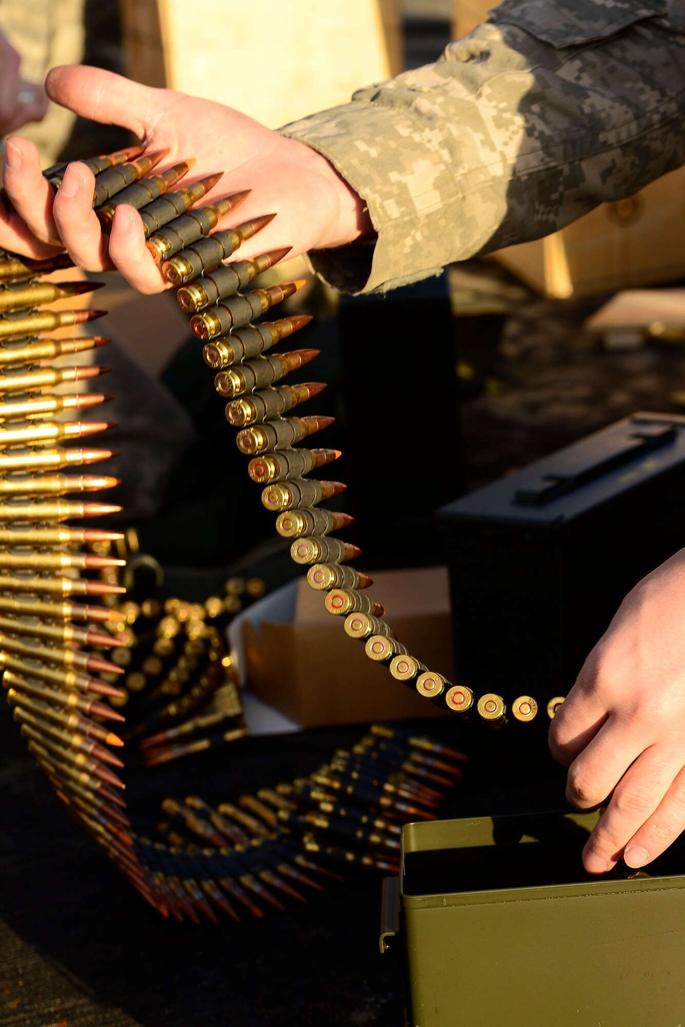 A U.S. Army National Guard soldier assigned to the 1st Battalion, 169th Aviation Regiment, Ft. Bragg, N.C., prepares bullets for a M240 machine gun at Poinsett Electronic Combat Range, Sumter, S.C., Feb. 6, 2015. In 2013, 754 aircraft utilized Poinsett for training. (U.S. Air Force photo by Airman 1st Class Diana M. Cossaboom/Released)