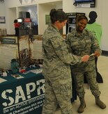 Colonel Margaret Jones, 628th Medical Group commander speaks with Staff Sgt. Lakin Trahan, 628th MDG during the Sexual Assault Prevention and Response Program Information Fair Jan. 28, 2015 at the Base Exchange on Joint Base Charleston, S.C. The purpose of the SAPR Information Fair was to educate people about the impact sexual assaults can have on a person and the community as a whole. In addition to being set up in the Base Exchange, there were information tables set up in the 628th MDG lobby and the Gaylor Dining Facility. (Courtesy photo) 

