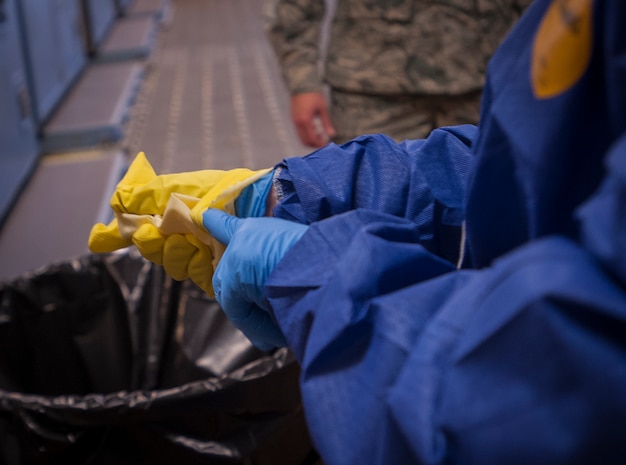 Chief Master Sgt. Shawn Hughes, 437th Airlift Wing command chief, wears protective gloves during infection prevention and control practice Feb. 5, 2015, at Joint Base Charleston – Air Base, S.C. The 437th  AW leadership stopped by the 437th Aerial Port Squadron to learn more about personal protective equipment and its benefits during the event of an emergency.  (U.S. Air Force photo / Senior Airman Tom Brading)