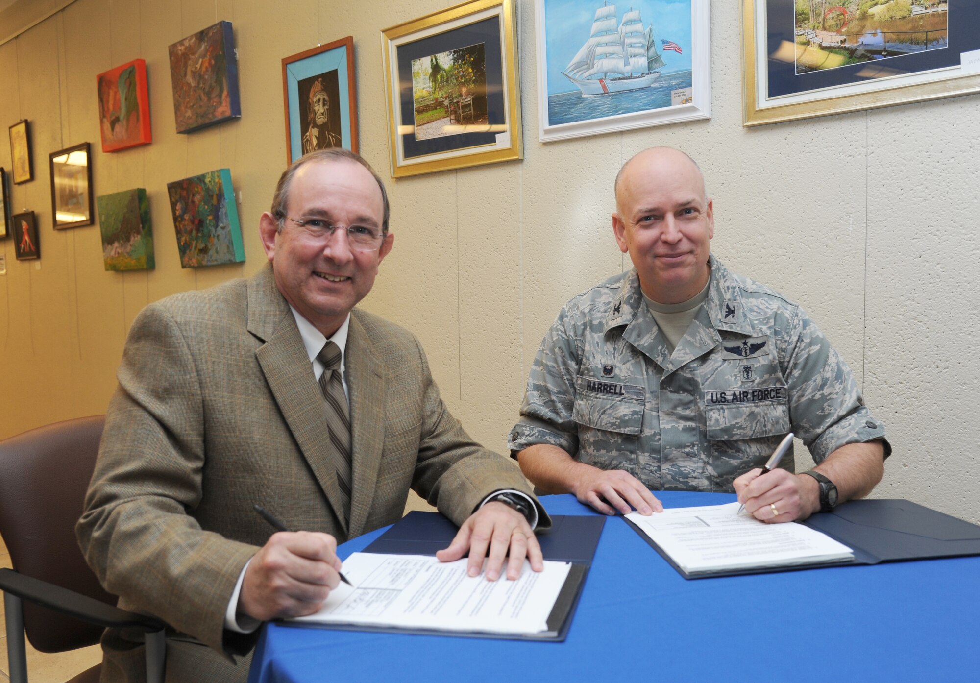 Col. Thomas Harrell, 81st Medical Group commander, and Charles Dickerson, Armed Forces Retirement Home Gulfport administrator, sign a Training Affiliation Agreement between the Keesler Medical Center and the Armed Forces Retirement Home Gulfport Feb. 9, 2014, at the Keesler Medical Center, Keesler Air Force Base, Miss. The agreement allows Keesler to send internal medicine physicians and residents to the AFRH for medical treatment. The agreement will allow retirees to receive treatment with physicians at the retirement home rather than travel to Keesler Medical Center. (U.S. Air Force photo by Kemberly Groue)