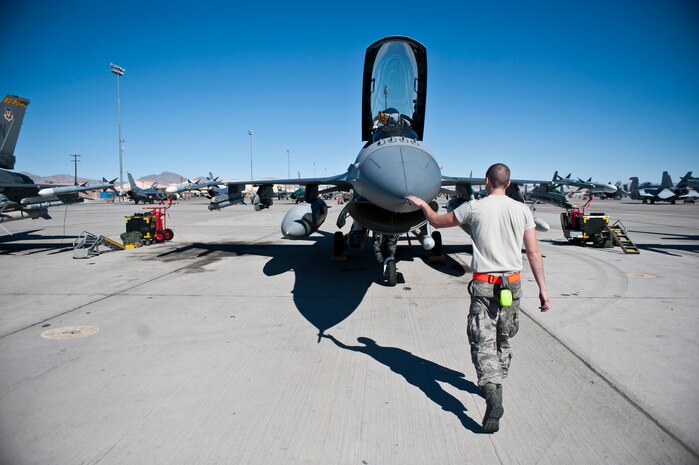 Airman 1st Class Aaron Hoffhines, a crew chief assigned to the 20th Aircraft Maintenance Squadron, Shaw Air Force Base, S.C., performs a pre-flight inspection prior to a Red Flag 15-1 training sortie at Nellis Air Force Base, Nev., Feb. 10, 2015. Red Flag is a realistic combat training exercise involving the air, space and cyber forces of the U.S. and its allies, and is conducted on the vast bombing and gunnery ranges on the Nevada Test and Training Range. (U.S. Air Force photo by Staff Sgt. Siuta B. Ika)