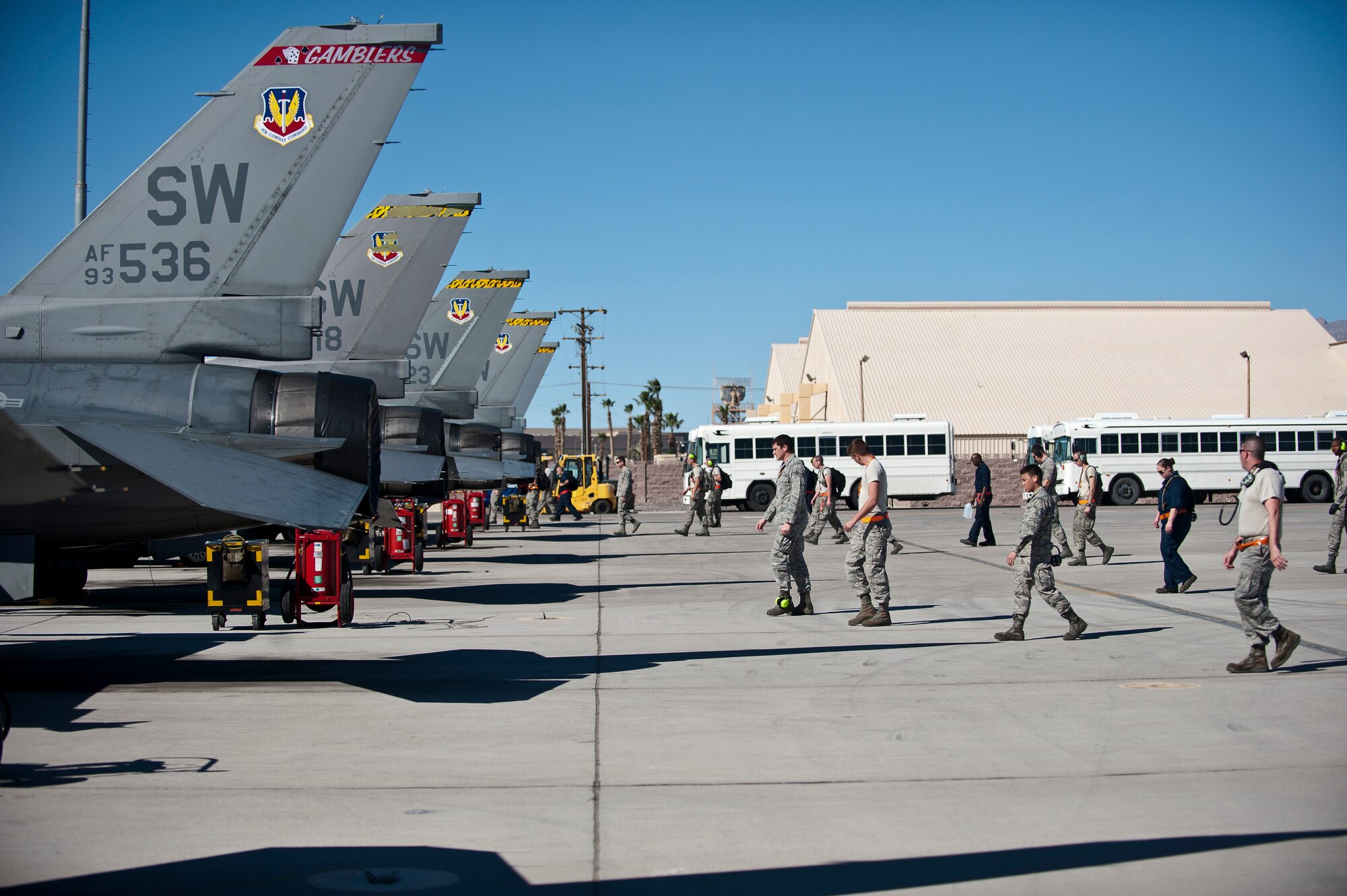 Maintainers assigned to the 20th Aircraft Maintenance Squadron, Shaw Air Force Base, S.C., perform a foreign object debris walk prior to a Red Flag 15-1 training sortie at Nellis Air Force Base, Nev., Feb. 10, 2015. FOD is a hazard for aircraft and other precision equipment, because objects sucked into the air intake of jet engines can cause serious damage. (U.S. Air Force photo by Staff Sgt. Siuta B. Ika)