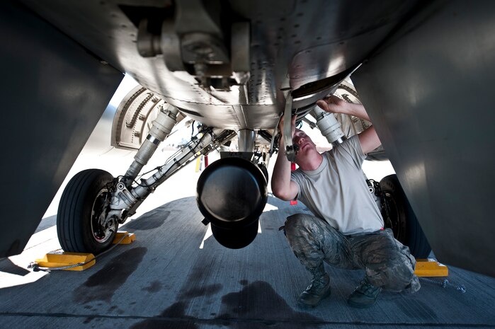 Airman 1st Class Aaron Hoffhines, a crew chief assigned to the 20th Aircraft Maintenance Squadron, Shaw Air Force Base, S.C., checks the undercarriage of an F-16 Fighting Falcon prior to a Red Flag 15-1 training sortie at Nellis Air Force Base, Nev., Feb. 10, 2015. Crew chiefs are responsible for overseeing the day-to-day maintenance of aircraft, including diagnosing malfunctions and replacing components, and conducting various inspections to ensure the aircraft is functioning properly. (U.S. Air Force photo by Staff Sgt. Siuta B. Ika)