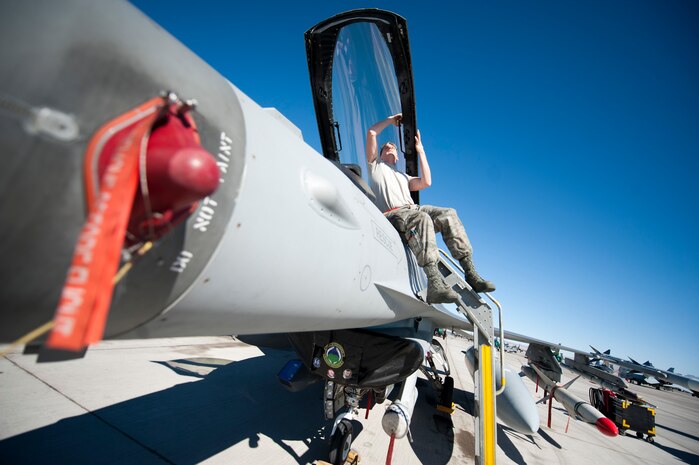 Airman 1st Class Aaron Hoffhines, a crew chief assigned to the 20th Aircraft Maintenance Squadron, Shaw Air Force Base, S.C., cleans the canopy of F-16 Fighting Falcon prior to a Red Flag 15-1 training sortie at Nellis Air Force Base, Nev., Feb. 10, 2015. Red Flag is a realistic combat exercise involving U.S. and allied air forces conducting training operations on the 15,000 square mile Nevada Test and Training Range. (U.S. Air Force photo by Staff Sgt. Siuta B. Ika)
