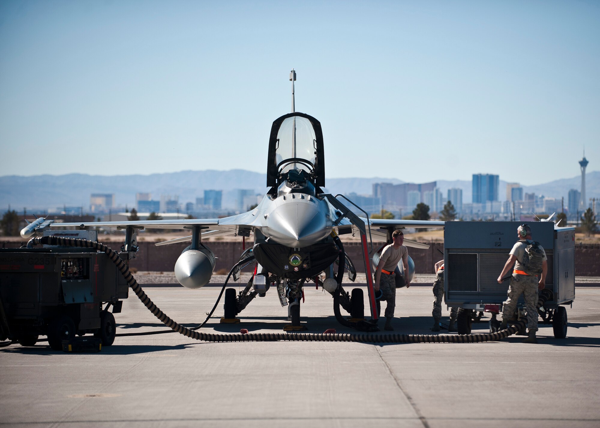 Crew chiefs assigned to the 20th Aircraft Maintenance Squadron, Shaw Air Force Base, S.C., work on an F-16 Fighting Falcon prior to a Red Flag 15-1 training sortie at Nellis Air Force Base, Nev., Feb. 10, 2015. Red Flag provides a series of intense air-to-air scenarios for aircrew and ground personnel to increase their combat readiness and effectiveness for future real-world operations. (U.S. Air Force photo by Staff Sgt. Siuta B. Ika)