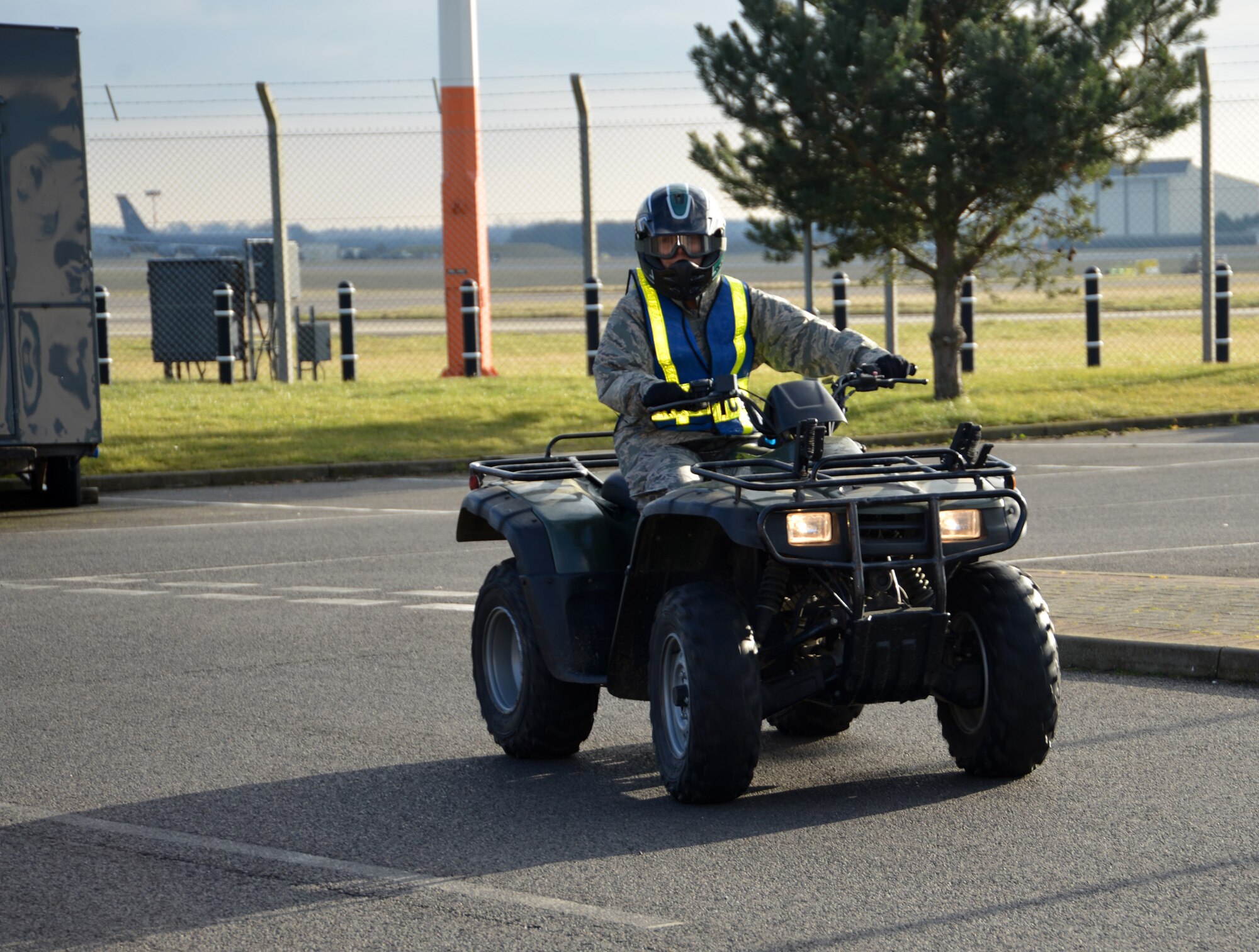 U.S. Air Force Chief Master Sgt. Kathryn Aleshire, 100th Mission Support Group command chief, completes a practice lap around the 100th Security Forces Squadron warehouse on an all-terrain vehicle Feb. 9, 2015, on RAF Mildenhall, England. Aleshire and U.S. Air Force Col. David Avila, 100th MSG commander, spent time learning more about the ATVs and their importance in accomplishing the mission as well as performing perimeter checks at the base. (U.S. Air Force photo by Karen Abeyasekere/Released)
