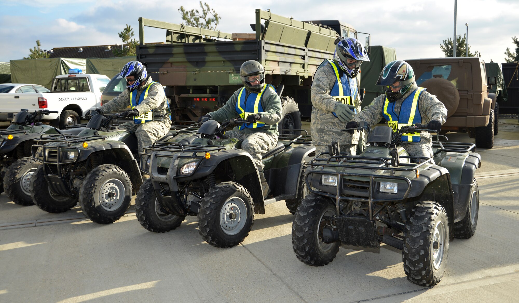 U.S. Air Force Master Sgt. Justin Aguilar, second from right, 100th Security Forces Squadron logistics and readiness superintendent from Escondido, Calif., runs through the controls on an all-terrain vehicle with U.S. Air Force Chief Master Sgt. Kathryn Aleshire, right, 100th Mission Support Group command chief, U.S. Air Force Col. David Avila, second from left, 100th MSG commander, and U.S. Air Force Staff Sgt. Samuel Perez, 100th SFS supply NCO in charge from Plainfield, Conn., as they prepare to perform perimeter checks Feb. 9, 2015, on RAF Mildenhall, England. In addition to learning more about the ATVs and their importance, the 100th MSG leadership helped check the structural integrity of the fence to ensure there was no damage. (U.S. Air Force photo by Karen Abeyasekere/Released)
