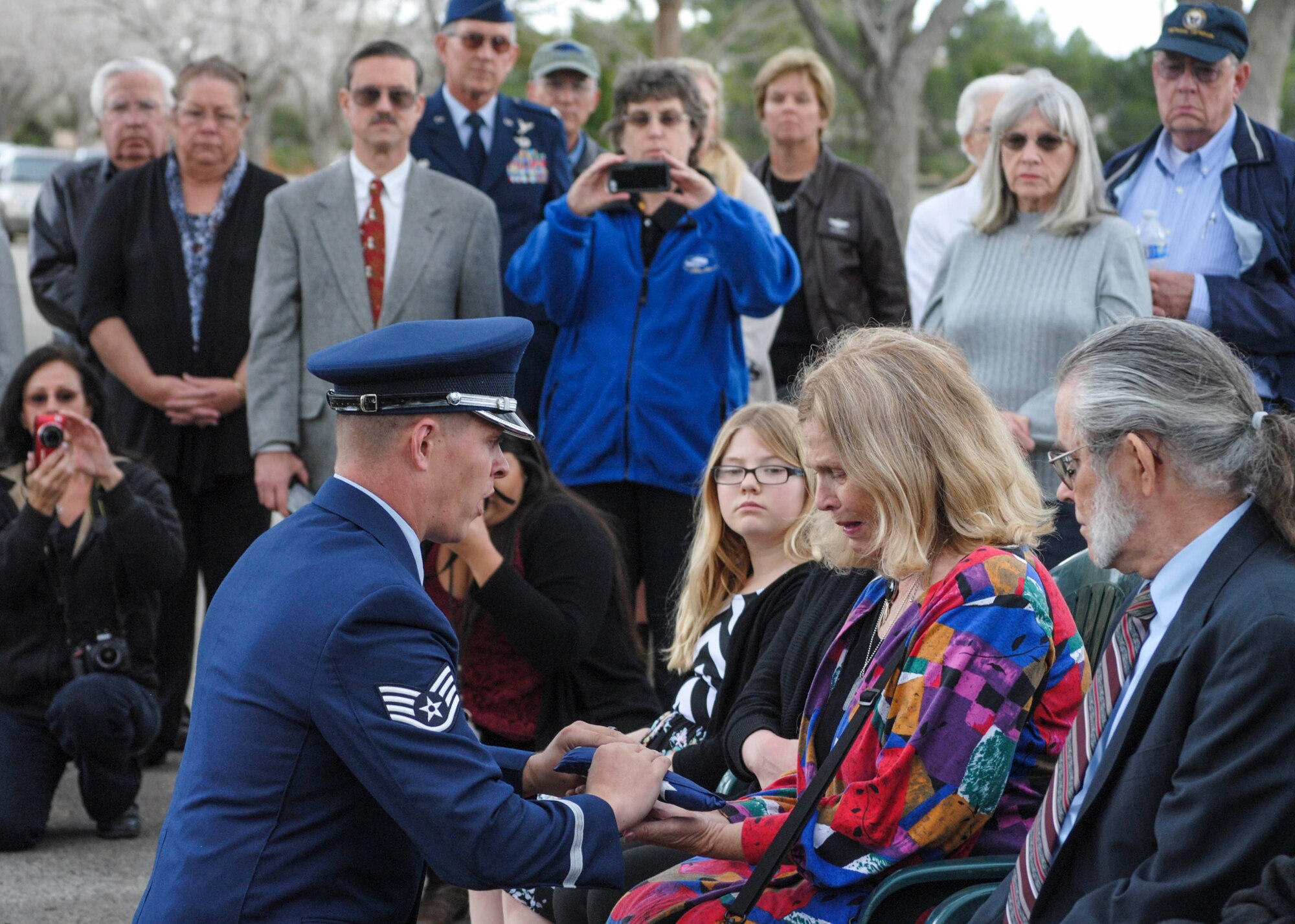 Staff Sgt. Kirk McDougal, 412th Aircraft Maintenance Squadron and Blue Eagles Honor Guard, presents Connie Fox, daughter of former WASP Flora Belle Reece, with an American Flag as a symbol of appreciation for Reece’s honorable and faithful service during World War II and beyond. The memorial service was held at Lancaster Ceremony in Lancaster, California, Feb. 7. (U.S. Air Force photo by Rebecca Amber)