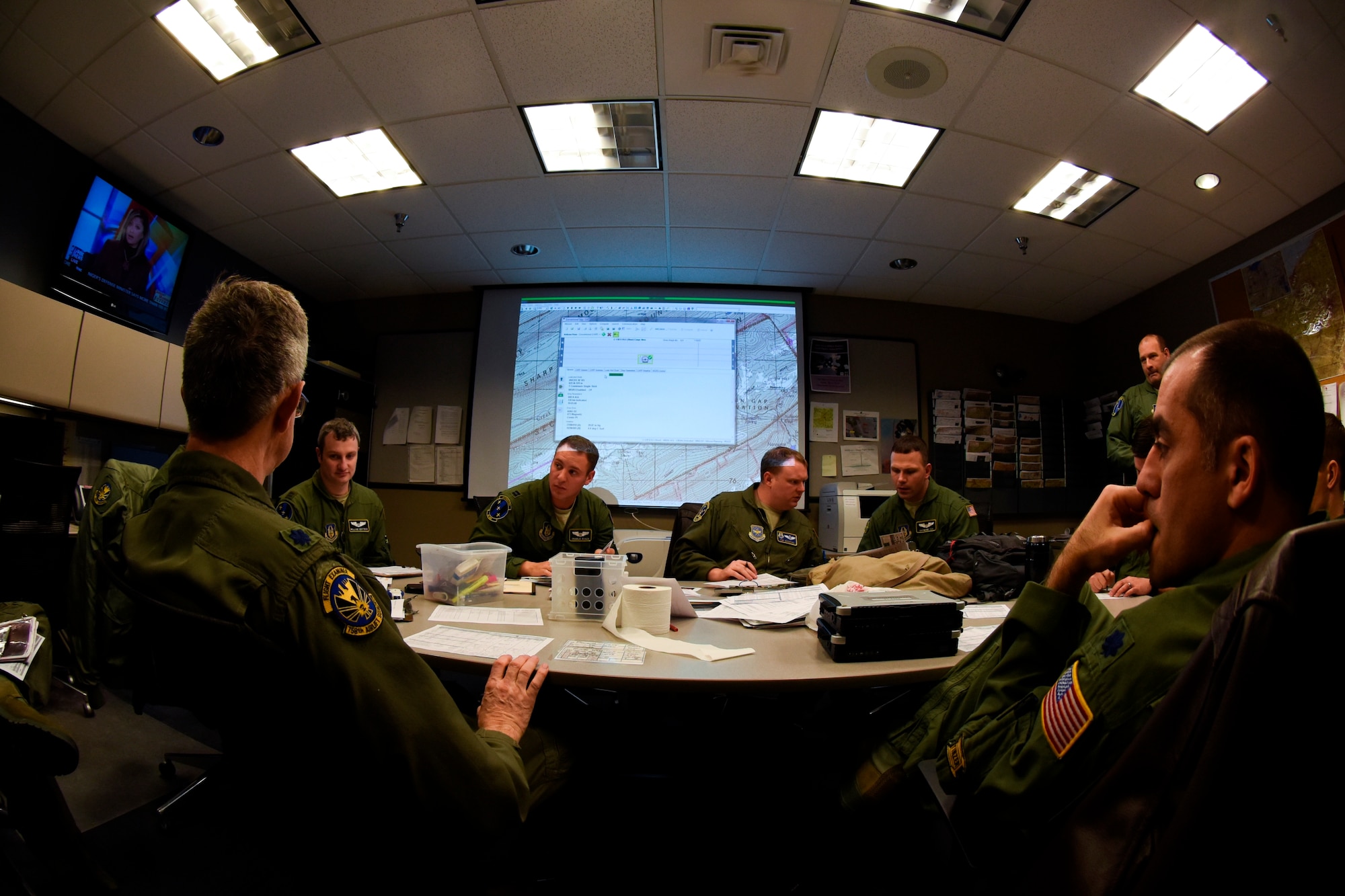 911th Operations Group navigators and pilots sit and discuss their routes for the airdrop mission to Bowling Green drop zone later in the day, Feb. 8, 2015. Pilots and navigators coordinate their C-130 Hercules formations and calculate Computed Air Release Points (CARP’s) before flying in order to perform at their best during the mission. (U.S. Air Force photo by Staff Sgt. Justyne Obeldobel)