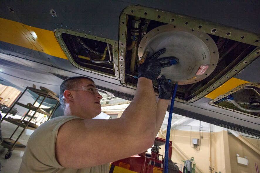 Airman 1st Class Matthew May, 108th Maintenance Squadron, lifts an air refueling pump into a KC-135R Stratotanker at the 108th Wing, New Jersey Air National Guard at Joint Base McGuire-Dix-Lakehurst, N.J., Feb. 7, 2015. (U.S. Air National Guard photo by Master Sgt. Mark C. Olsen/Released)