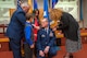 Brig. Gen. Michael L. Cunniff, left, The Adjutant General of New Jersey, assists Lt. Col. Thomas P. Coppinger’s wife Alane, right, and their children, Aidan, second from left, and Melissa, in properly attaching the colonel’s eagles on their father’s epaulettes during an Assumption of Command and promotion ceremony at Joint Base McGuire-Dix-Lakehurst, N.J., Feb. 8, 2015. The 108th Operations Group is part of the 108th Wing, New Jersey Air National Guard. (U.S. Air National Guard photo by Master Sgt. Mark C. Olsen/Released)